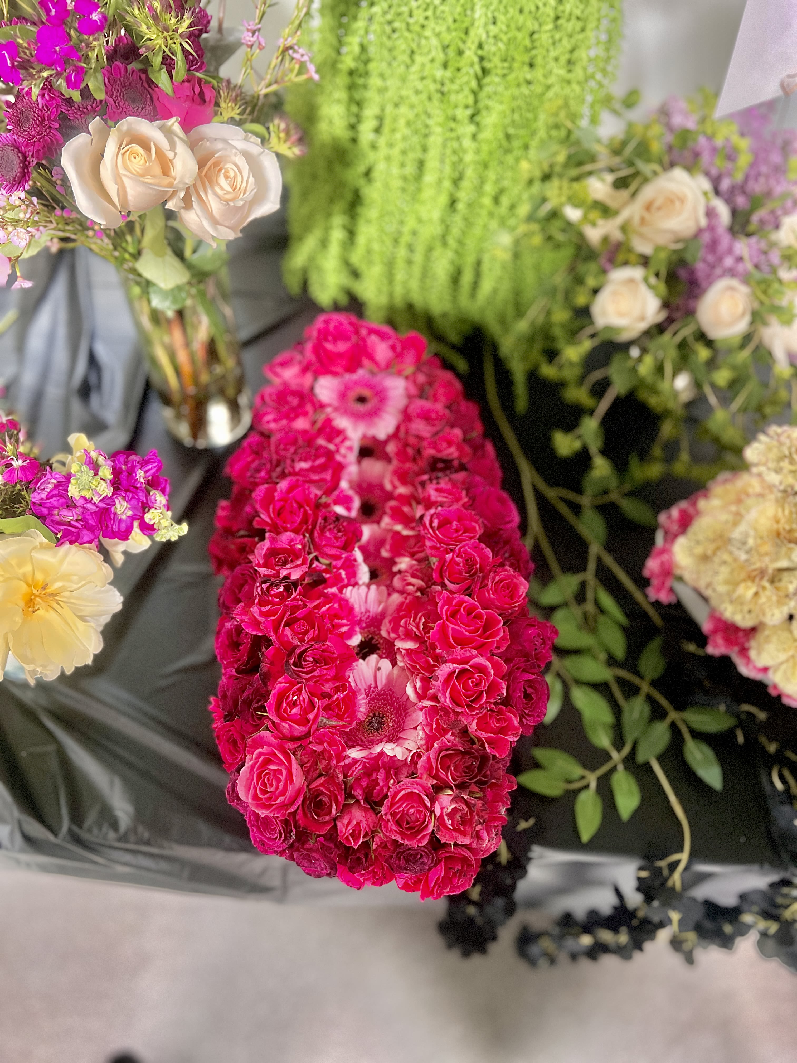 Bright pink rose and gerbera floral arrangement with cream roses