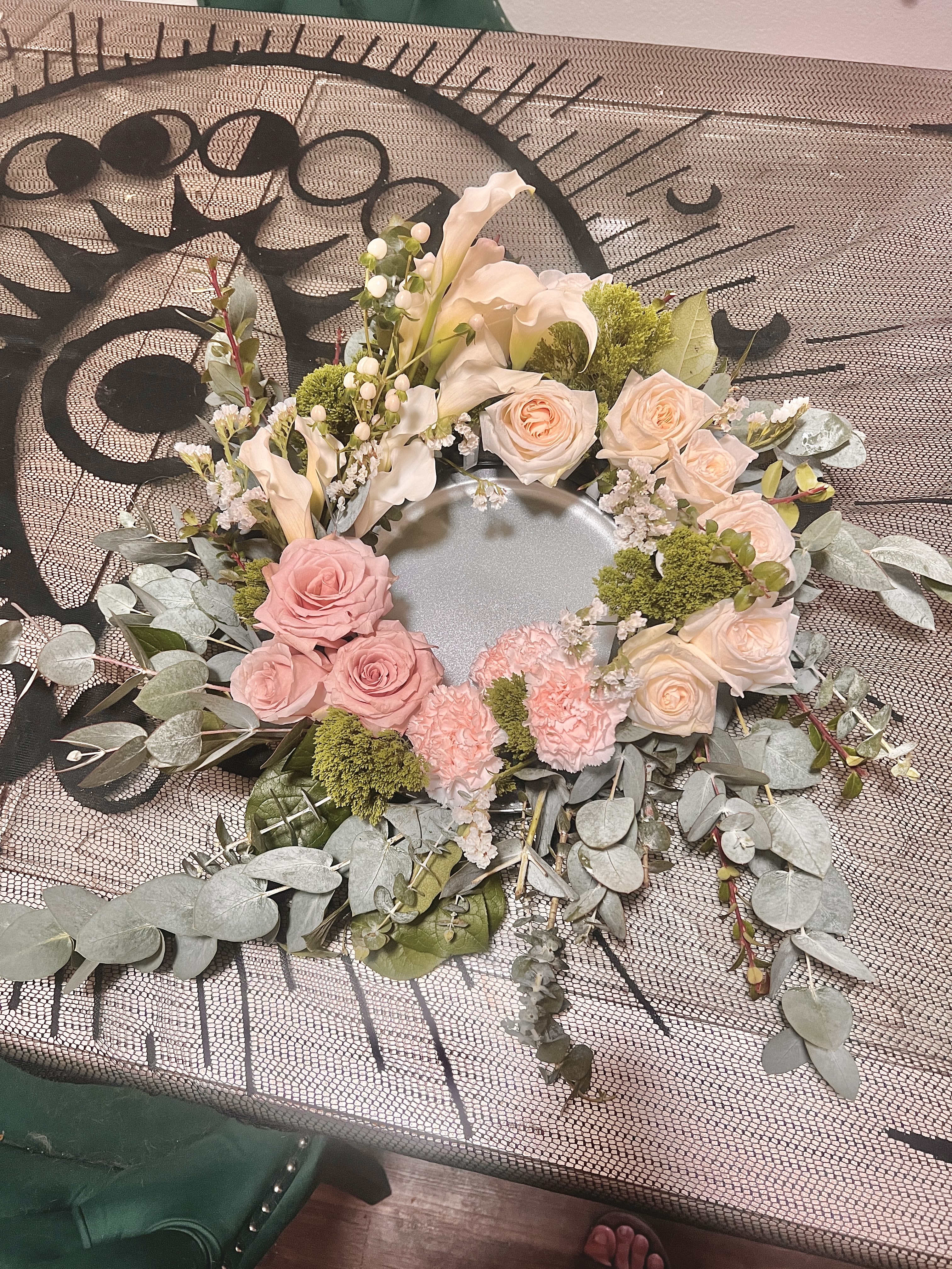 Circular floral wreath with pink and cream roses and calla lilies
