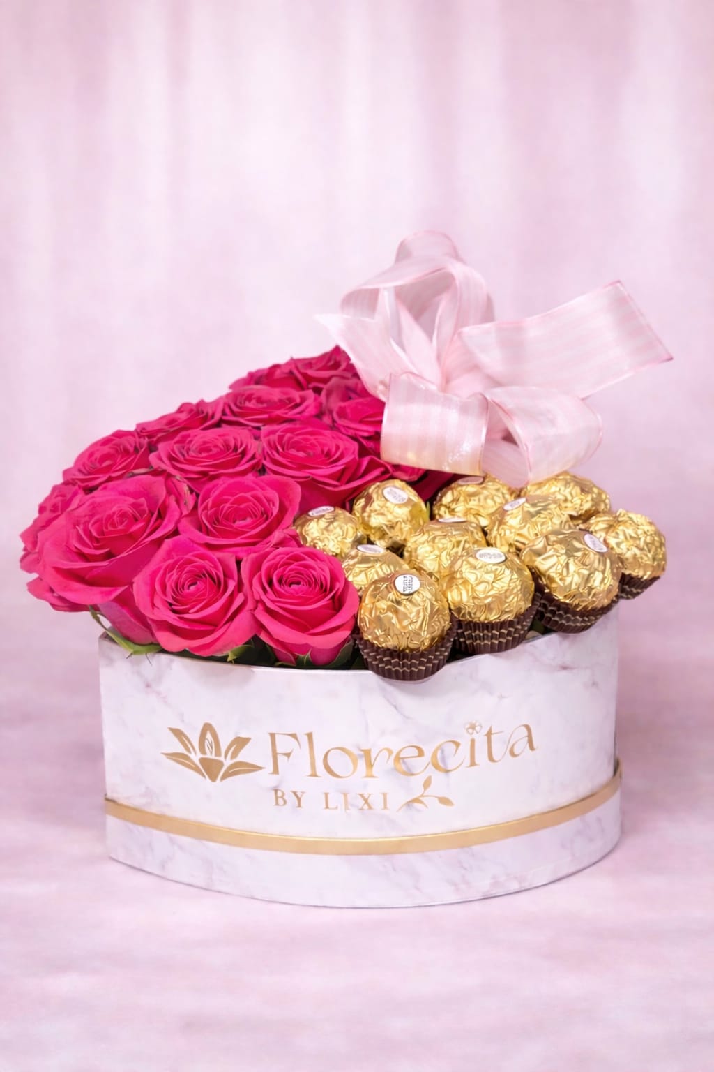 Sweet Luxury - Sweet Luxury is a romantic heart-shaped gift box featuring a dozen premium roses paired with a dozen Ferrero Rocher chocolates, beautifully arranged in our signature Florecita by Lixi marble keepsake box and finished with a matching ribbon. A perfect blend of flowers and indulgence, this design is crafted to make any celebration feel extra special.  **Please note your rose color preference (red, light pink or hot pink) in the notes during checkout**