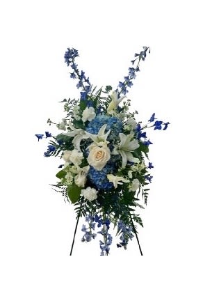 Tall blue and white funeral spray on a stand