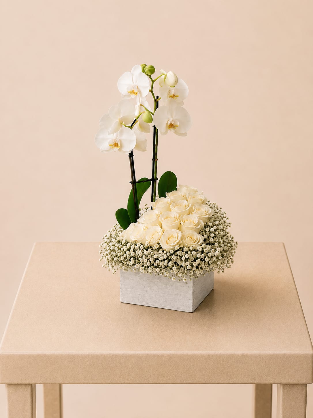 White orchids and cream roses in a square white box