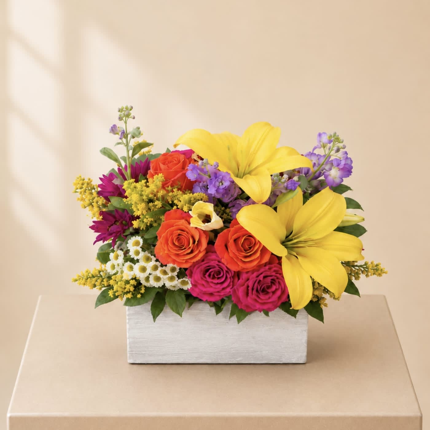 Colorful flower arrangement in a white rectangular box