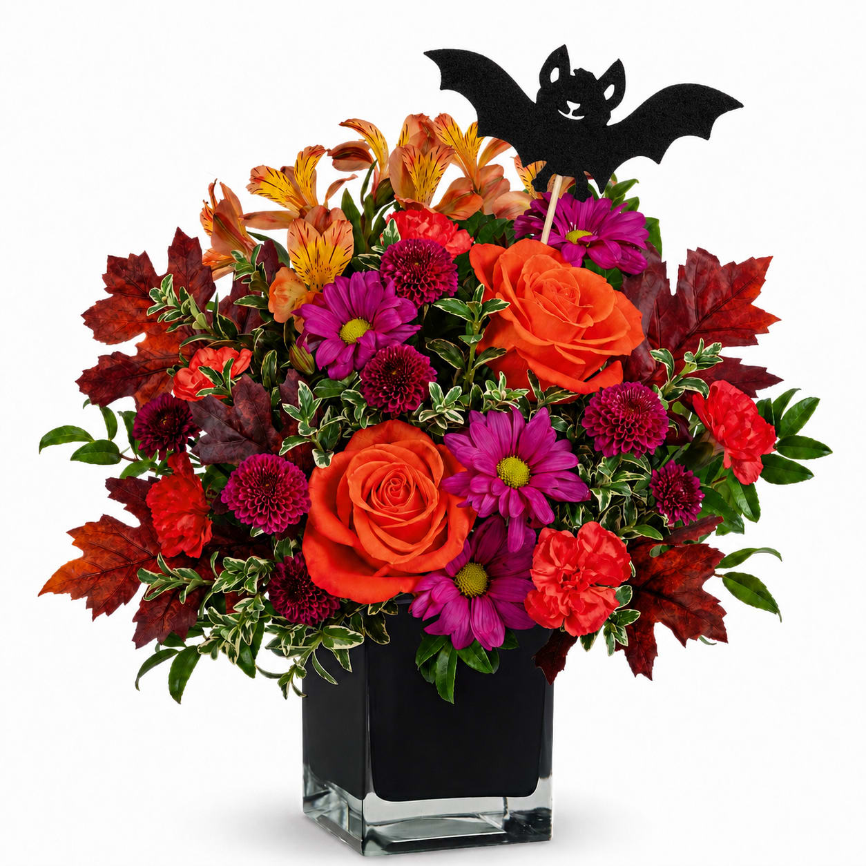 Orange and magenta flowers in a black vase with a bat pick