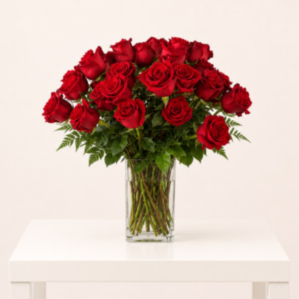 12 Red Roses in Gathering Vase - Classic and timeless floral arrangement designed with 12 premium red roses accented with fresh, natural greenery in a clear gathering glass vase. The visible stems in water create a fresh and elegant presentation inspired by luxury floral boutique styling. Designed with a soft organic shape, this arrangement is perfect for romantic gestures, anniversaries, birthdays, or meaningful celebrations.  Perfect for: Anniversary, Love &amp; Romance, Birthday, Valentine’s Day, Thinking of You  Available for local flower delivery throughout Naples, Bonita Springs, Estero, Fort Myers and Fort Myers Beach.  Designer’s Choice: Each arrangement is uniquely designed using the freshest seasonal flowers available. Flower varieties, colors and containers may vary while maintaining the overall style, value and beauty of the design.