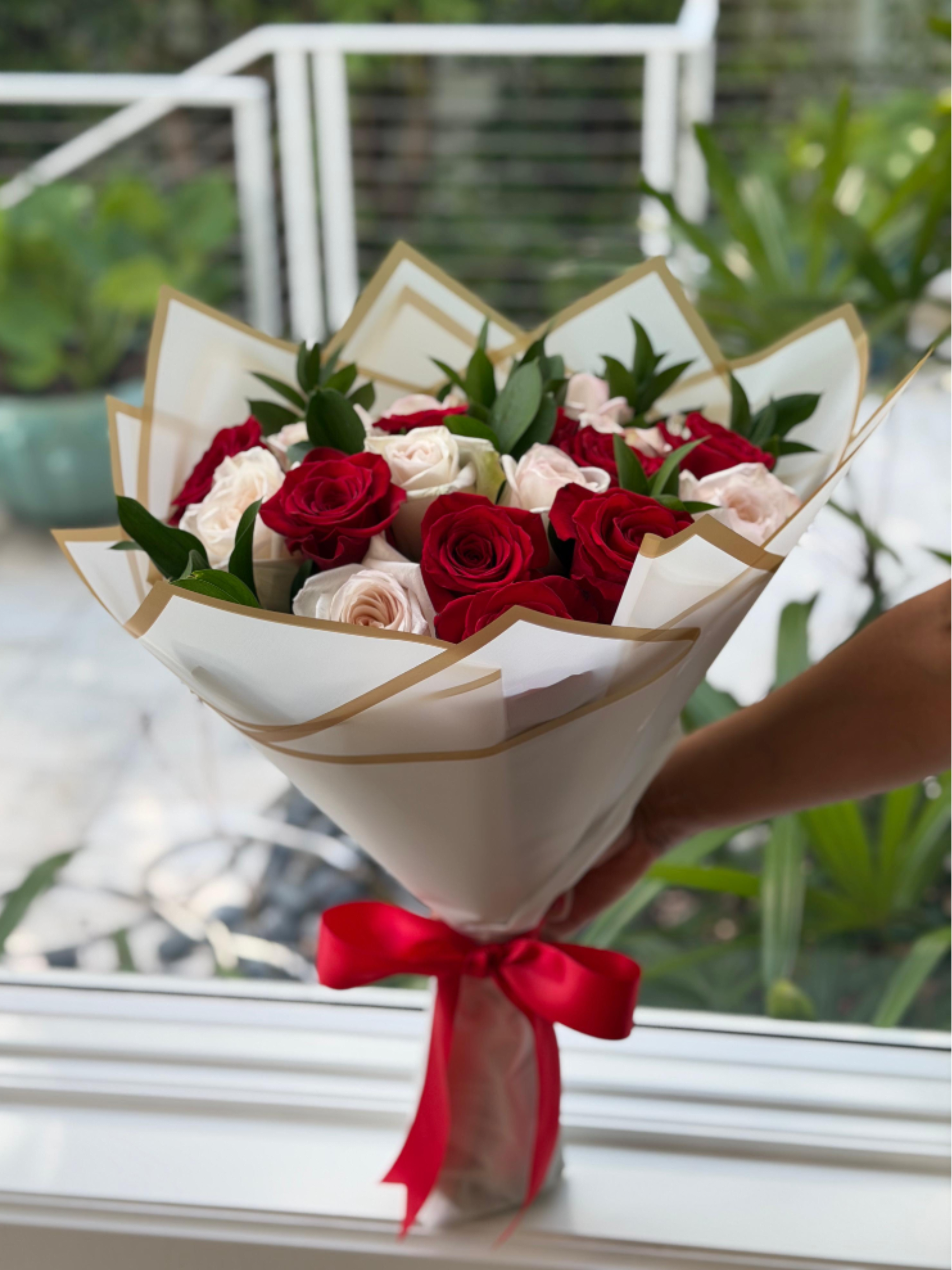 Nineteen Roses, One Love - This custom bouquet was specially designed to celebrate 19 beautiful years together. Featuring 19 premium roses in romantic shades of red and white, each bloom represents a year of love, cherished memories, shared experiences, and unwavering commitment.  Thoughtfully arranged and elegantly wrapped, this bouquet is more than a floral gift—it’s a meaningful tribute to a love story that continues to grow and bloom through the years.  Available for local flower delivery throughout Naples, Bonita Springs, Estero, Fort Myers and Fort Myers Beach.  Designer’s Choice: Each arrangement is uniquely designed using the freshest seasonal flowers available. Flower varieties, colors and containers may vary while maintaining the overall style, value and beauty of the design.