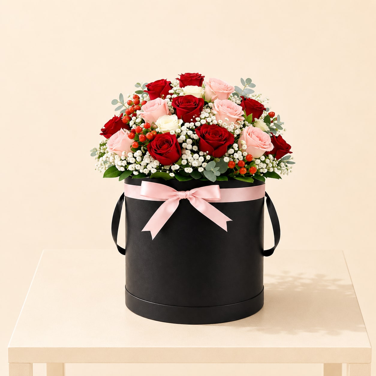 Blush &amp; Red Rose Hatbox – Tall - A luxurious floral arrangement featuring 24 roses in rich red, soft blush, and ivory tones, accented with delicate white blooms and fresh greenery. Designed in a tall black hatbox and finished with a soft blush ribbon for an elegant and timeless presentation.  Perfect for Mother’s Day, anniversaries, birthdays, romantic gestures, or celebrating meaningful moments in a refined way.  Available for local flower delivery throughout Naples, Bonita Springs, Estero, Fort Myers and Fort Myers Beach.  Designer’s Choice: Each arrangement is uniquely designed using the freshest seasonal flowers available. Flower varieties, colors and containers may vary while maintaining the overall style, value and beauty of the design.