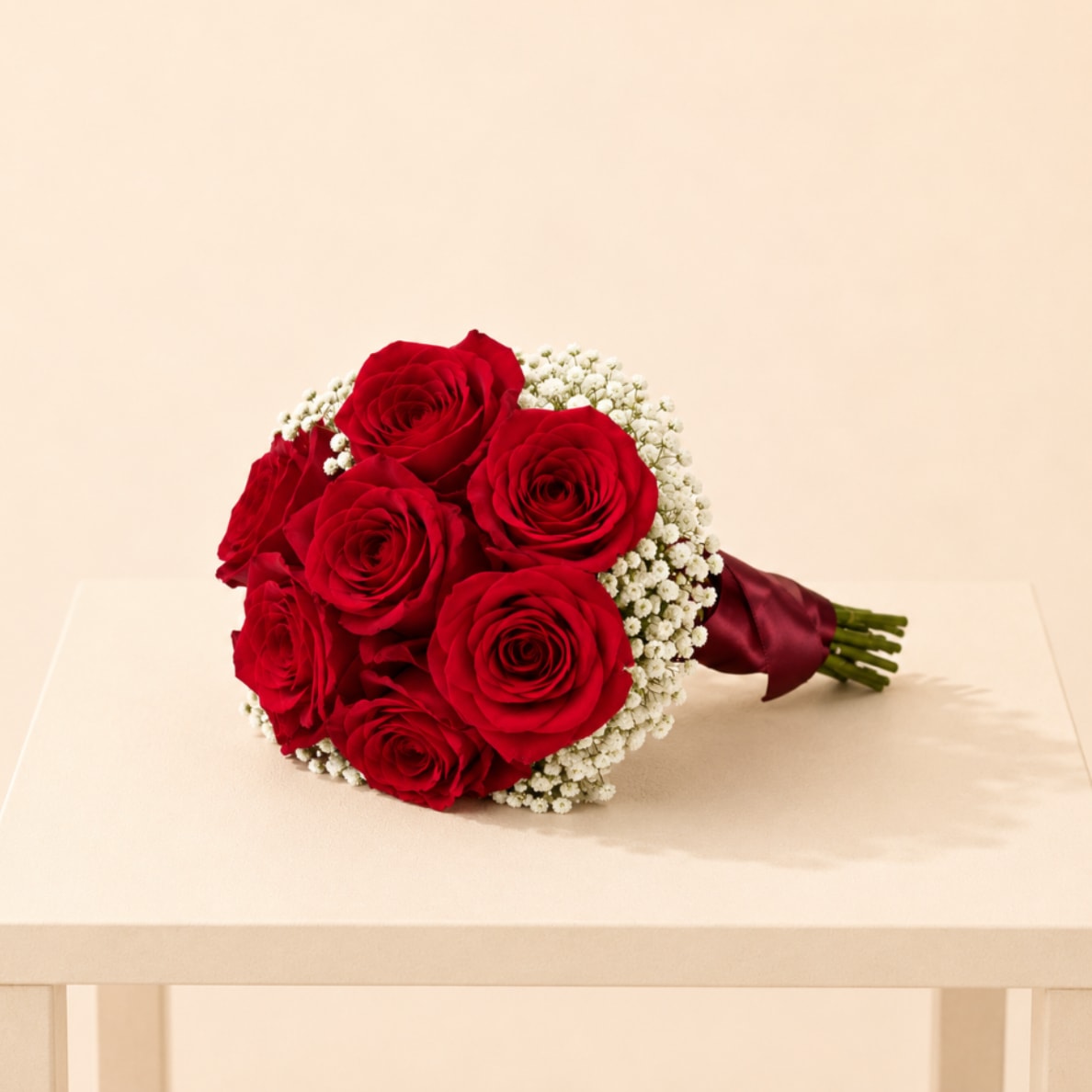 Bouquet of red roses with white baby's breath and burgundy ribbon
