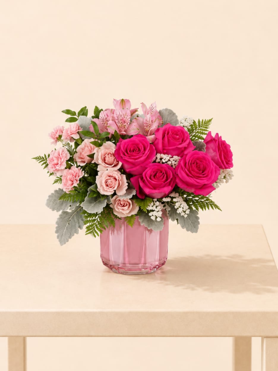 Romantic Pink Garden - A lovely mix of hot pink and blush roses, mini carnations, alstroemeria, and textured greenery—arranged in a soft pink vase. This bouquet is bright, sweet, and full of charm.  Better for: Valentine’s Day, Anniversary, Love &amp; Romance, Birthday, Thinking of You, Just Because.  Available for local flower delivery throughout Naples, Bonita Springs, Estero, Fort Myers and Fort Myers Beach.  Designer’s Choice: Each arrangement is uniquely designed using the freshest seasonal flowers available. Flower varieties, colors and containers may vary while maintaining the overall style, value and beauty of the design.