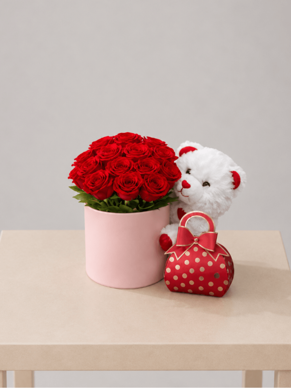 Love &amp; Roses Gift Set™ - A romantic gift set featuring a lush arrangement of premium red roses, beautifully designed in a blush hatbox and paired with a soft teddy bear and a festive gift bag filled with chocolates. A complete and thoughtfully curated surprise that delivers love, sweetness, and joy in one unforgettable presentation.  Perfect for Valentine’s Day, anniversaries, romantic gestures, saying “I love you,” or celebrating life’s most meaningful moments.  Available for local flower delivery throughout Naples, Bonita Springs, Estero, Fort Myers and Fort Myers Beach.  Designer’s Choice: Each arrangement is uniquely designed using the freshest seasonal flowers available. Flower varieties, colors and containers may vary while maintaining the overall style, value and beauty of the design.