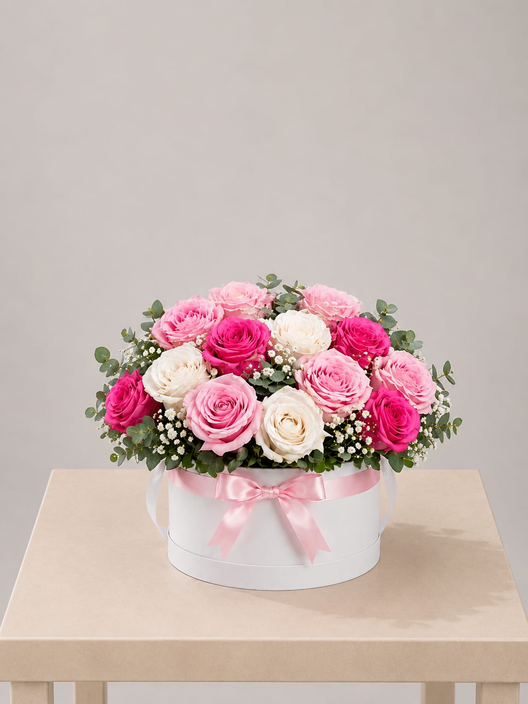 Blush &amp; Pink Rose Hat Box – Short  - A refined and elegant floral design featuring a curated mix of hot pink, blush pink, and classic white roses, beautifully arranged in a modern white hat box and finished with a soft satin ribbon.  Designed in a low, compact style, this arrangement highlights the natural beauty of each rose with soft texture and a balanced, polished presentation. Accented with delicate baby’s breath and fresh greenery, it creates a romantic look that feels both modern and timeless.  Better for: Mother’s Day, birthdays, thank you, get well, or a thoughtful everyday gesture.  Available for local flower delivery throughout Naples, Bonita Springs, Estero, Fort Myers and Fort Myers Beach.  Designer’s Choice: Each arrangement is uniquely designed using the freshest seasonal flowers available. Flower varieties, colors and containers may vary while maintaining the overall style, value and beauty of the design.
