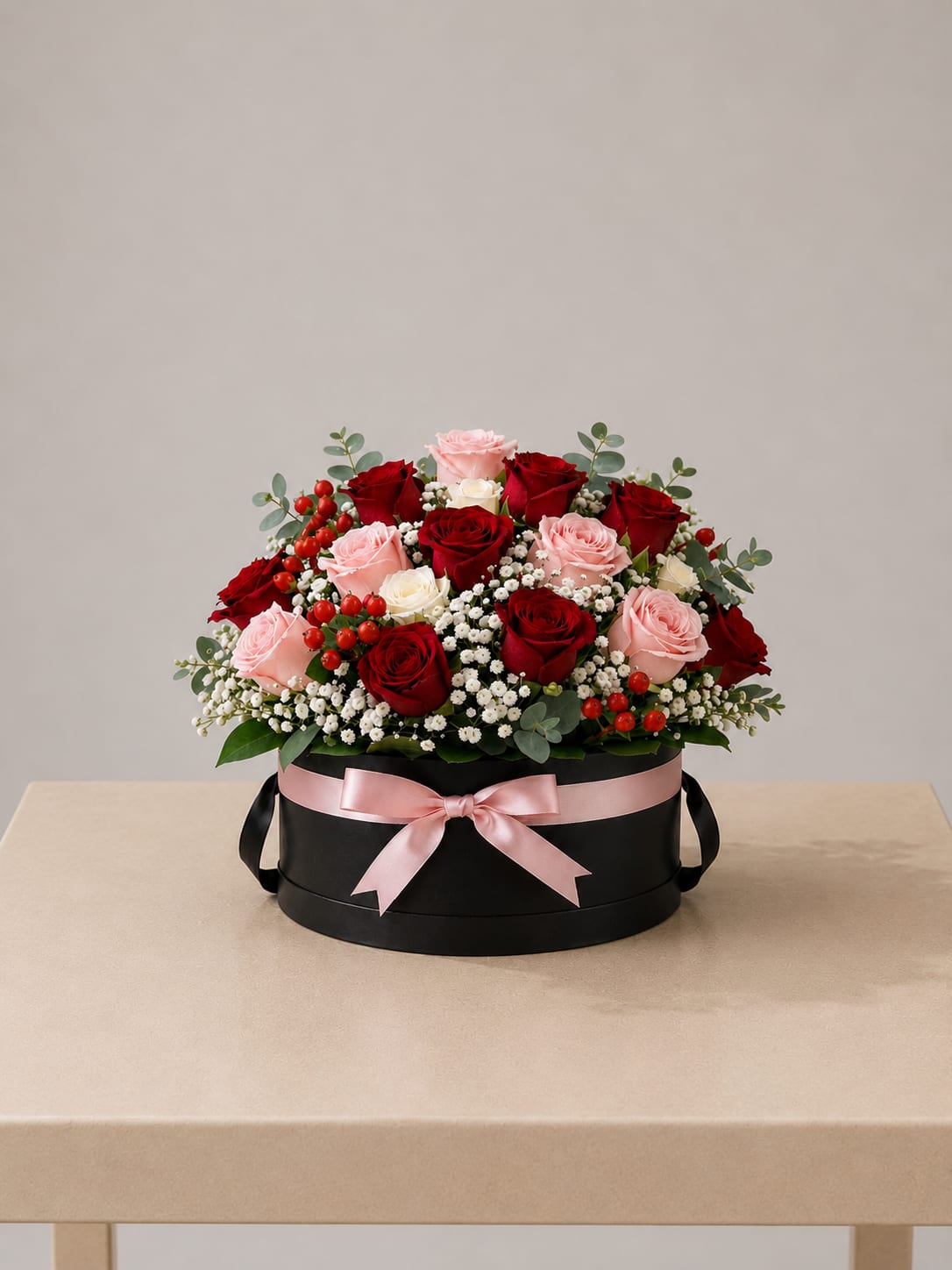 Blush &amp; Red Rose Hatbox – Short - This refined floral design features 18 roses in rich red, soft blush, and ivory hues, beautifully arranged with delicate white accents and fresh greenery in a sleek black hatbox. A romantic, modern, and thoughtfully crafted arrangement for meaningful moments.  Perfect for Mother’s Day, birthdays, anniversaries, Women’s Day, or a beautiful “just because” gesture.  Available for local flower delivery throughout Naples, Bonita Springs, Estero, Fort Myers and Fort Myers Beach.  Designer’s Choice: Each arrangement is uniquely designed using the freshest seasonal flowers available. Flower varieties, colors and containers may vary while maintaining the overall style, value and beauty of the design.