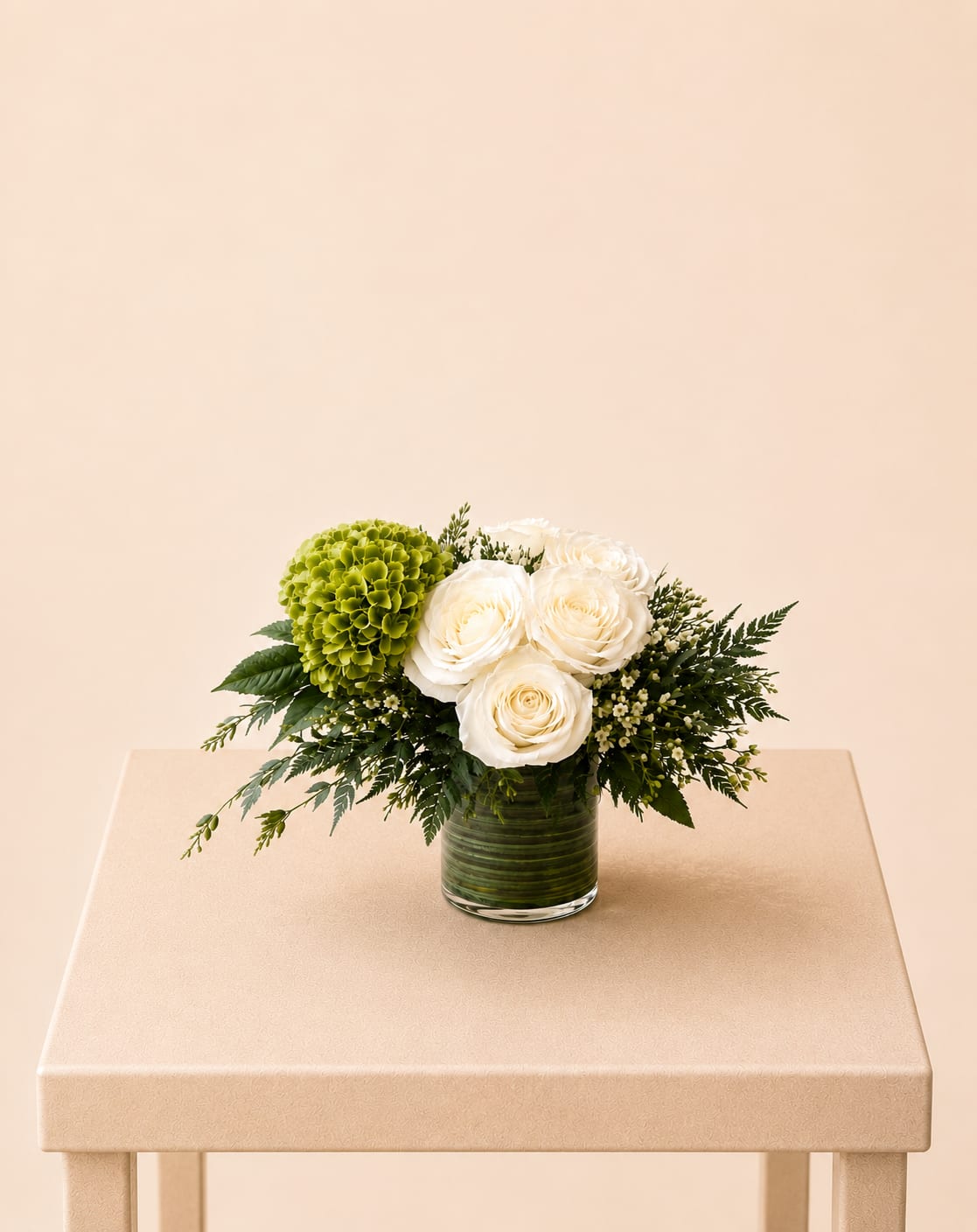 Elegant White Roses &amp; Greens - A fresh and organic flower arrangement featuring ivory roses, lush green accents, and delicate filler blooms, beautifully designed in a textured glass vase. Thoughtfully composed to capture a natural, refined aesthetic, this design brings effortless elegance and softness to any space.  Perfect for Mother’s Day, birthdays, anniversaries, thank you gestures, get well wishes, sympathy, or a meaningful “just because” surprise.  Available for local flower delivery throughout Naples, Bonita Springs, Estero, Fort Myers and Fort Myers Beach.  Designer’s Choice: Each arrangement is uniquely designed using the freshest seasonal flowers available. Flower varieties, colors and containers may vary while maintaining the overall style, value and beauty of the design.