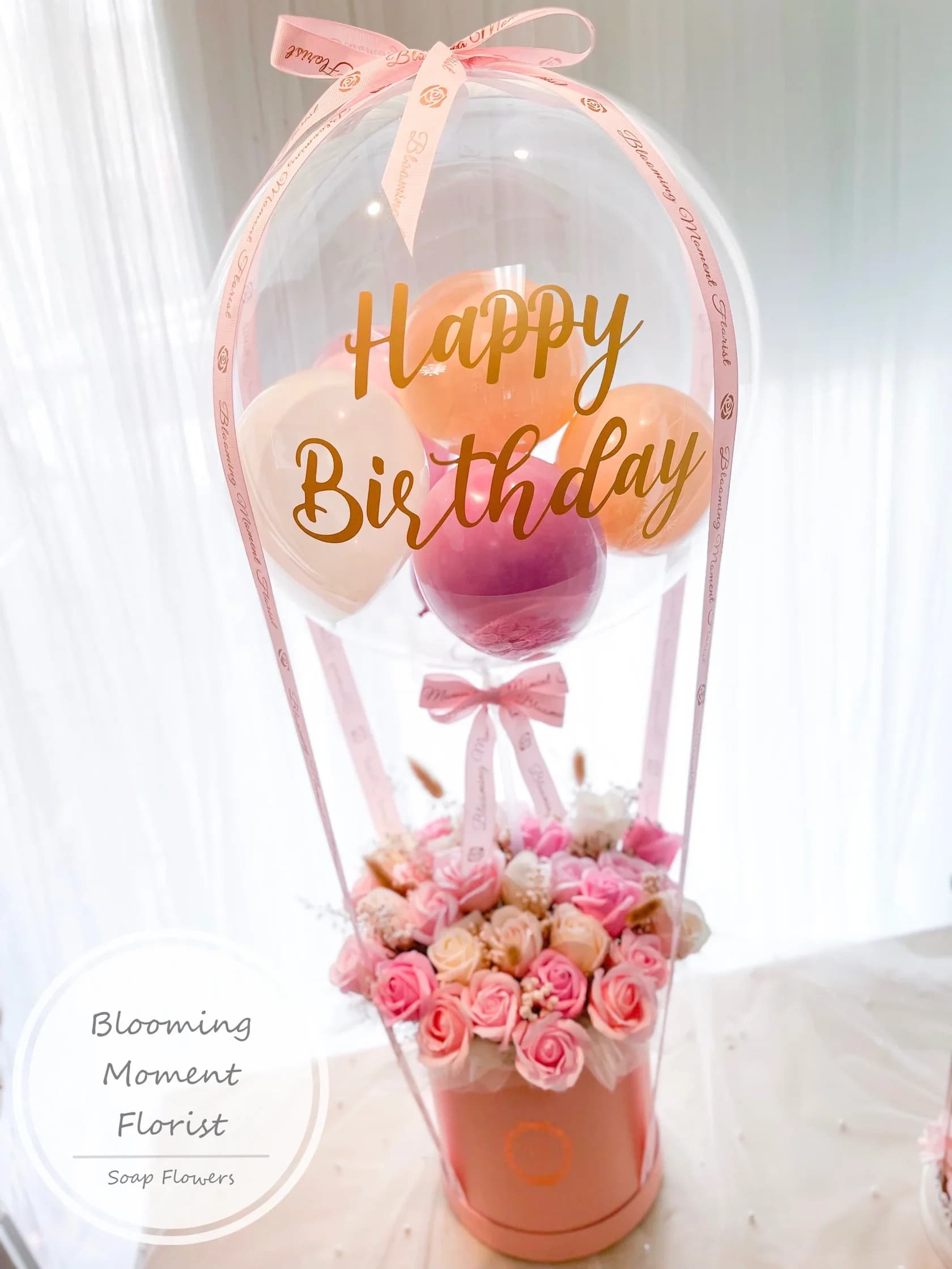 Pink birthday balloon arrangement with roses in a box