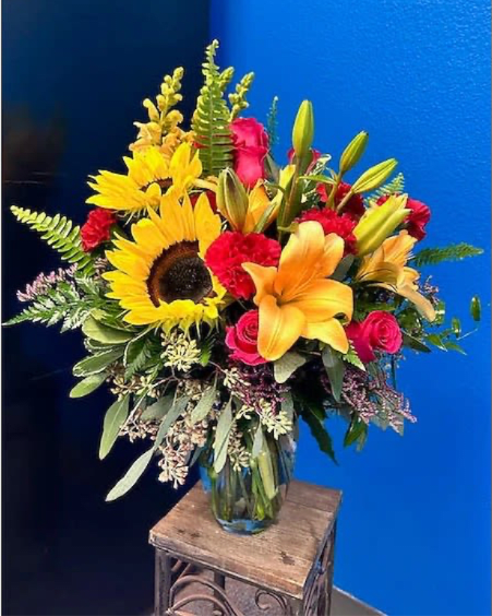 Colors Of The Sun - (ONE-SIDED) Give them the colors of the Sun in a beautiful bouquet with roses, sunflowers and lilies.