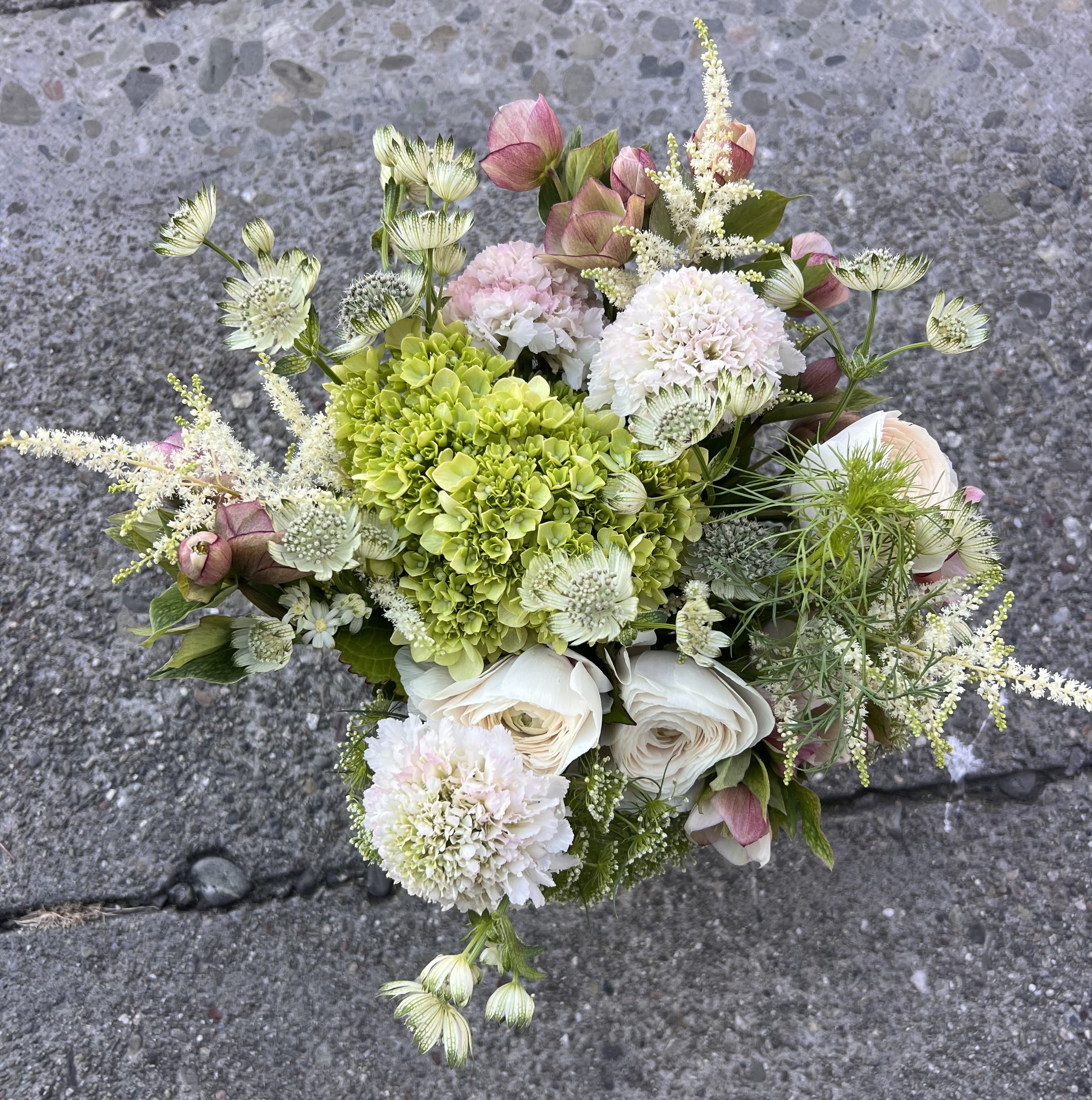 Soft Meadow  - A light and elegant mix of soft greens, creamy whites, and blush pinks. Hydrangea, ranunculus, and delicate wildflower accents create a fresh, airy bouquet that feels like a gentle morning.
