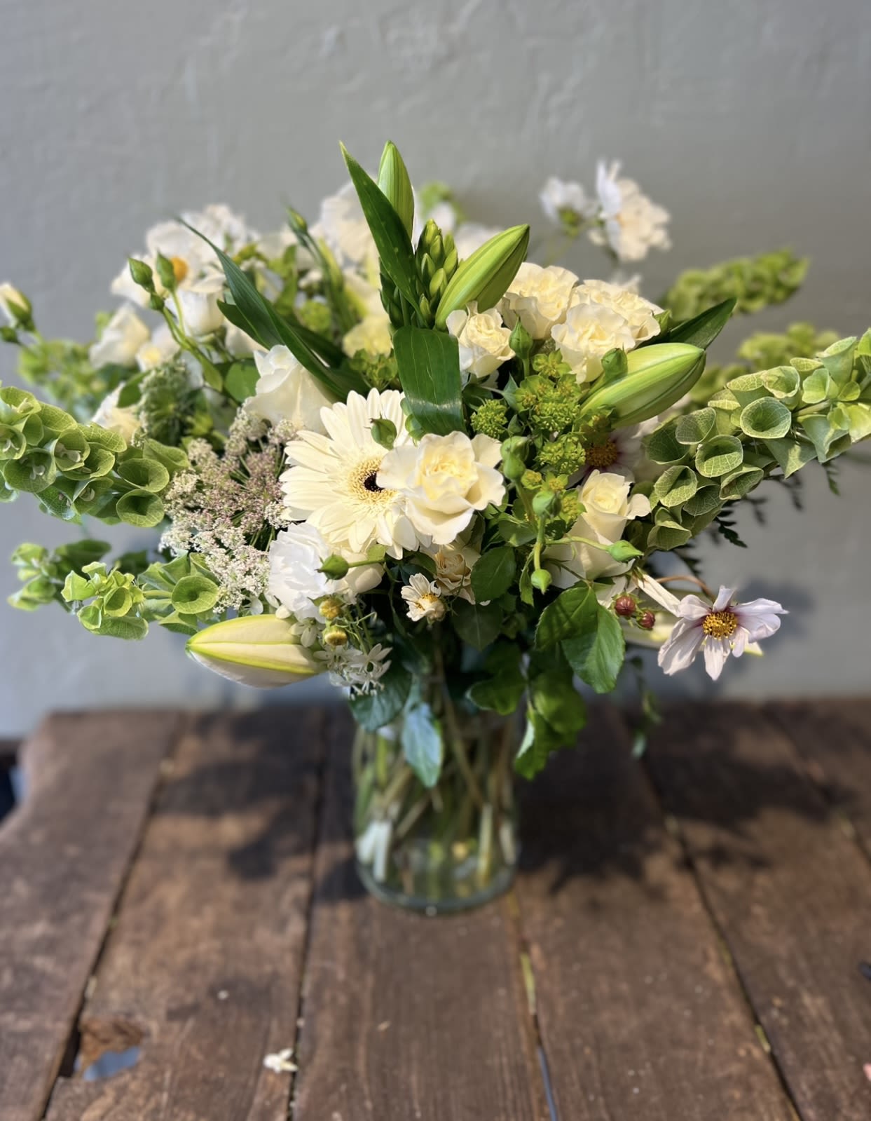Soft Moss - A serene mix of creamy whites and verdant greens, Soft Moss feels organic, gentle, and elevated. This arrangement is thoughtfully styled to bring freshness and quiet elegance to any setting.