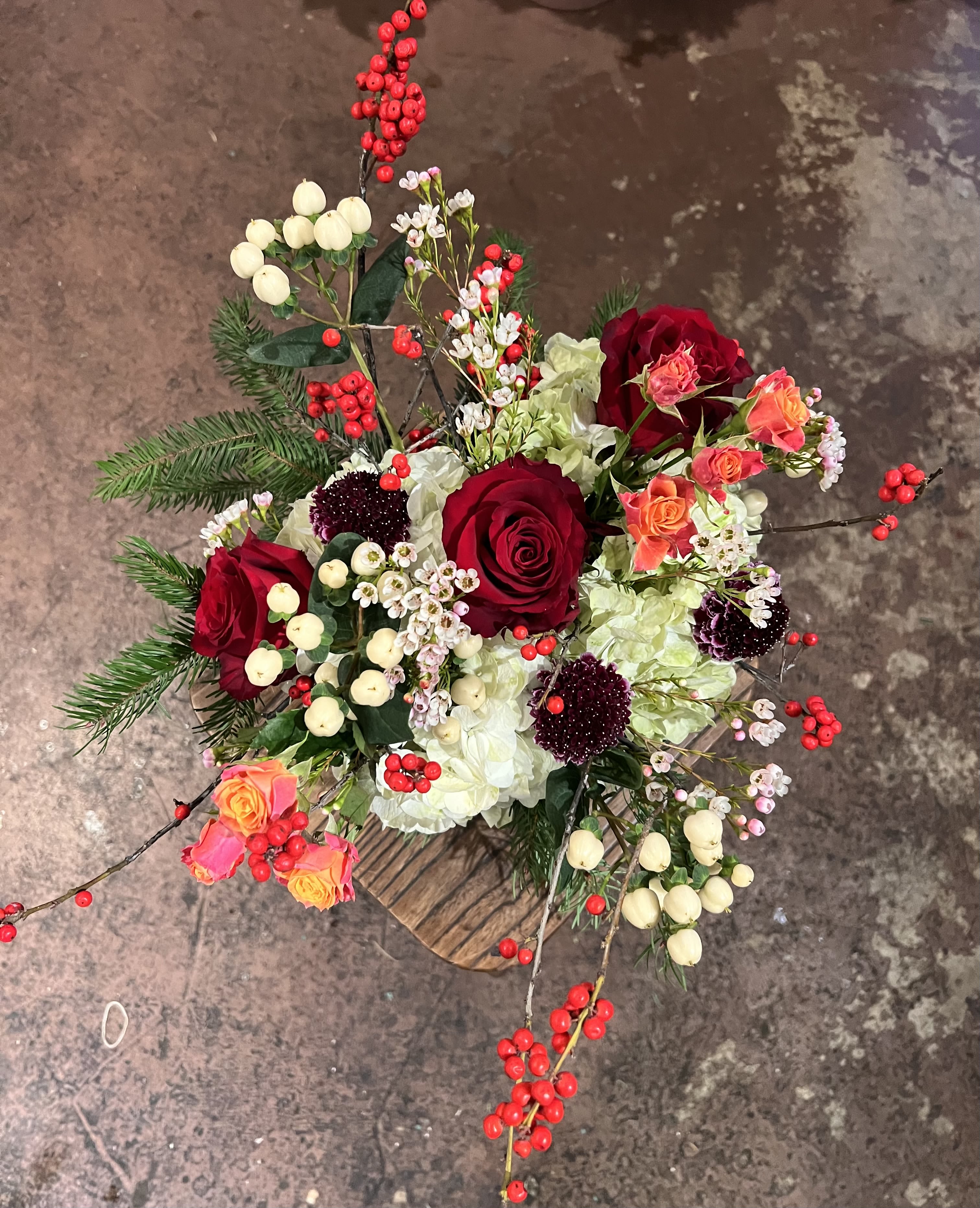  Winter Berry  - Inspired by winter’s quiet beauty, Evergreen Love features romantic red roses nestled among fresh greenery, soft blooms, and berry details. This arrangement is full of depth, texture, and timeless charm—perfect for meaningful winter moments. 