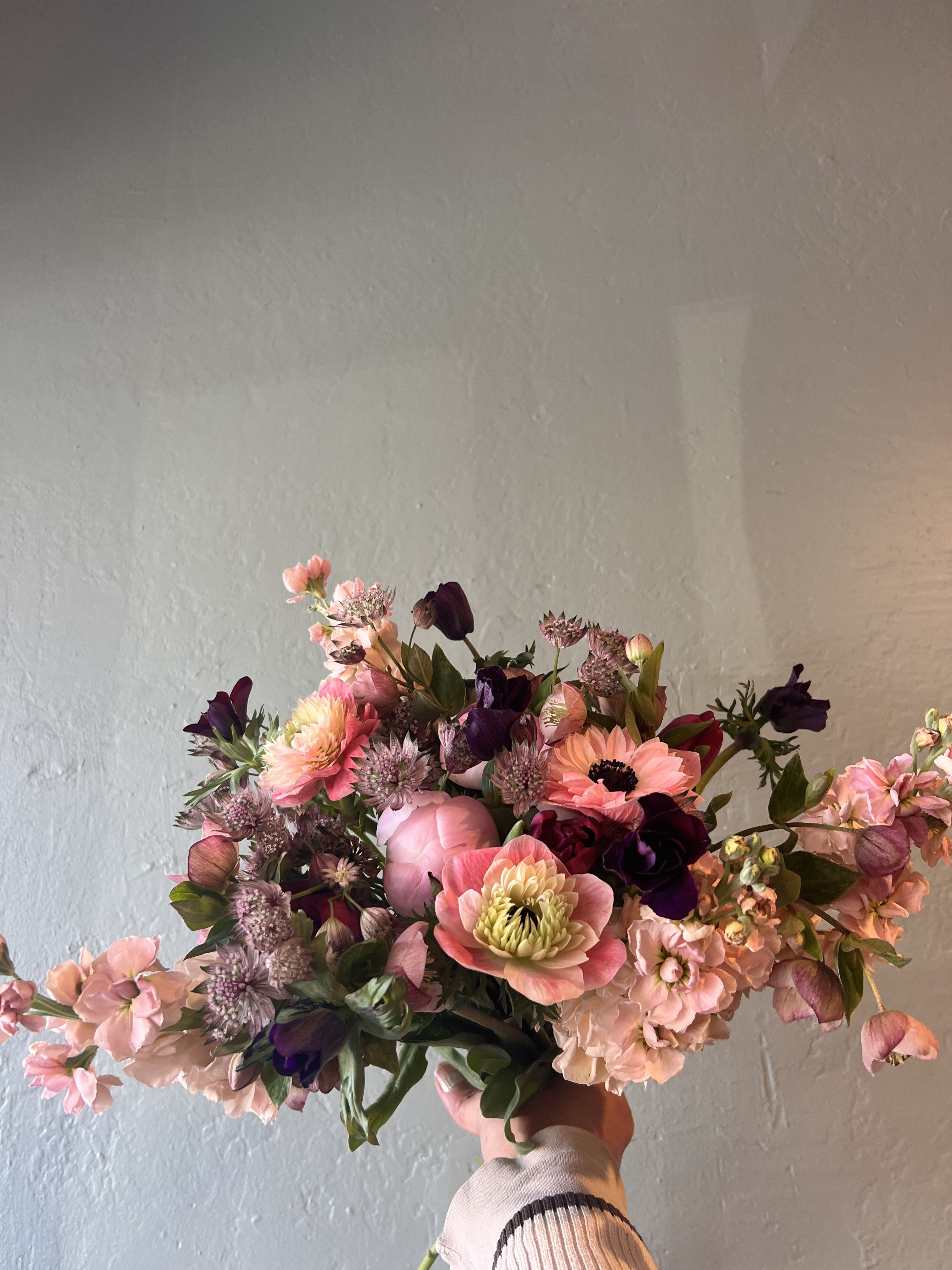 Belle Rosée - Belle Rosée is a refined garden-style floral arrangement featuring premium seasonal blooms in soft blush, rose, mauve, and delicate berry tones. Designed with graceful movement and layered textures, this luxury bouquet highlights specialty flowers such as anemones, ranunculus, hellebore, and curated foliage, artfully arranged to evoke timeless elegance and feminine beauty.  Handcrafted by a professional florist, Belle Rosée is perfect for anniversaries, birthdays, romantic gestures, and elevated everyday flower delivery. Each arrangement is uniquely created using the freshest flowers available, offering a bespoke floral experience that embodies modern luxury, romance, and artisanal design. 