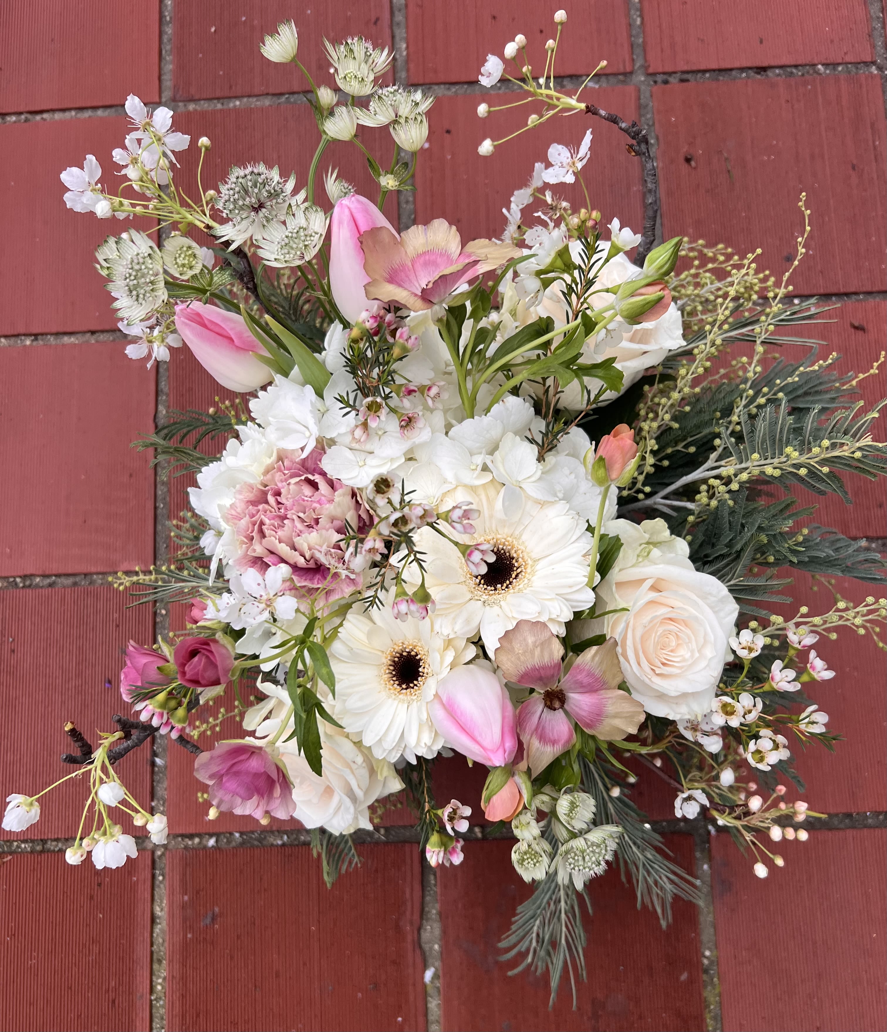 Blush Softy  - Blush Softy  is a soft, garden-inspired floral arrangement featuring a delicate mix of pink tulips, blush and ivory roses, white gerbera daisies, carnations, anemone, astrantia, wax flowers, cherry blossom branches, and seasonal greenery. Designed with natural movement and airy textures, this bouquet captures the beauty of a blooming spring garden.  Perfect for birthdays, anniversaries, spring celebrations, baby showers, bridal moments, thank-you gifts, and everyday flower delivery, this arrangement is handcrafted by our expert florists using fresh, premium flowers. Ideal for those searching for luxury floral arrangements, romantic garden-style bouquets, pastel flowers, spring flower delivery, and custom flower designs.
