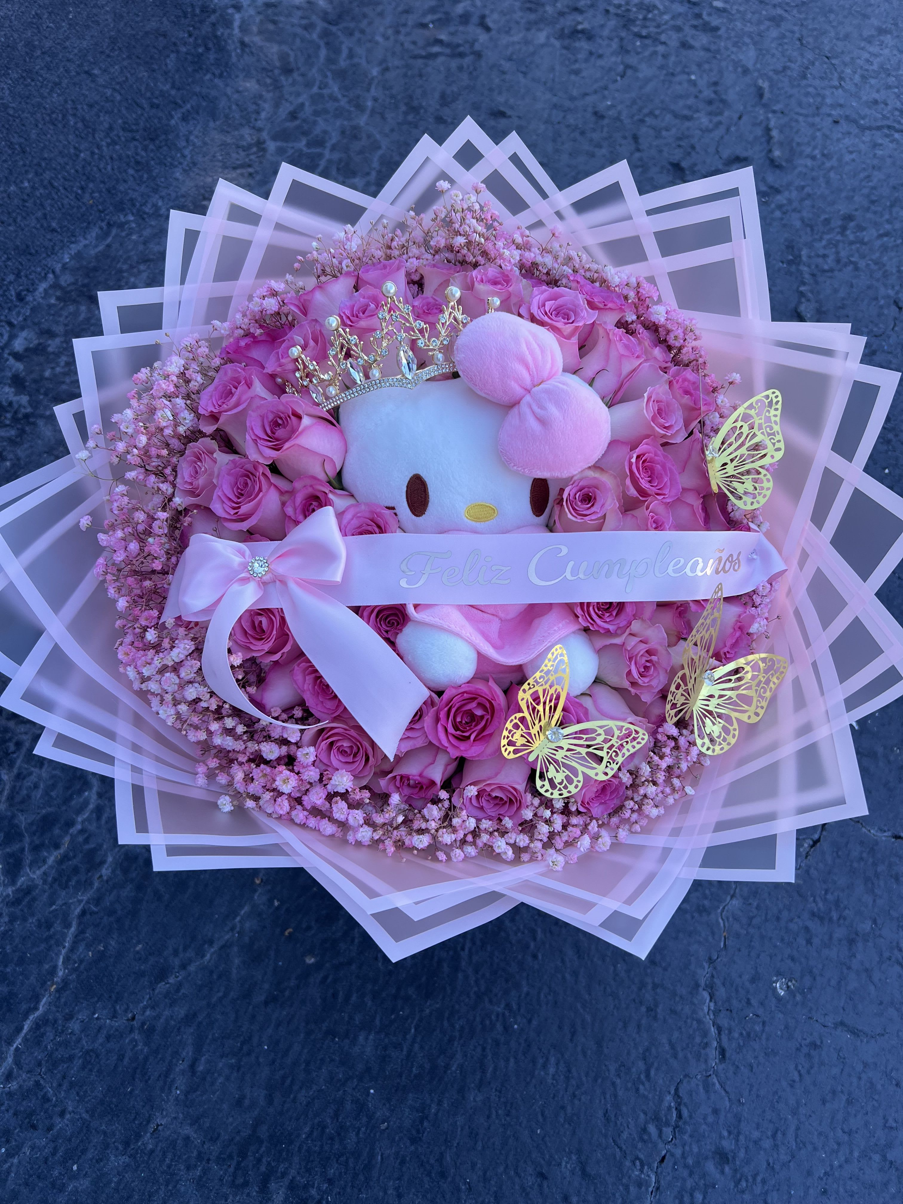 Pink rose bouquet with a Hello Kitty plush and birthday ribbon