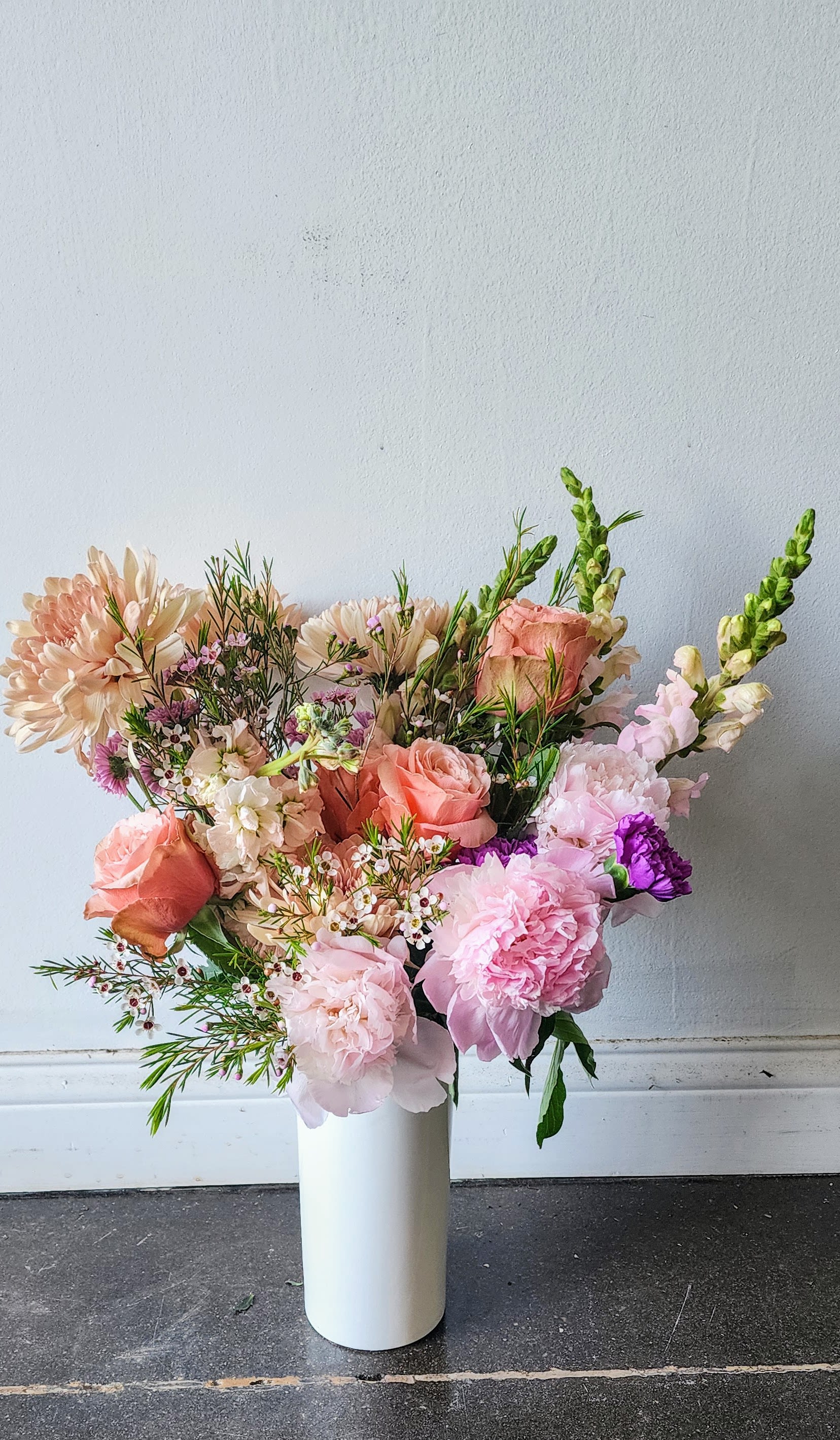 Small Standing Tall Ceramic Flower Arrangement-Soft &amp; Elegant - Indulge your loved one with our exquisite Standing Tall Arrangement! Out Standing Tall flower arrangement is perfect for styling n evntryway table.  Select your preferred flower color palette and let out florists surprise you with a selection of blooms that are unique to this time of year.  Perfect for expressing gratitude and love, this luxurious arrangement is sure to make your loved one feel cherished. Order now!  *Flowers and vases are natural and artisan products, and no two arrangements are exactly alike. While your arrangement may differ slightly from the photo, it will be designed with the same style and color palette of your choice. Occasionally, substitutions of vases may be necessary due to market availability, but we will always substitute with a vase of equal or greater value.