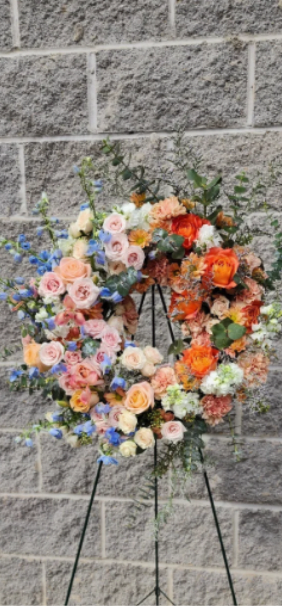 Ombre Sympathy Wreath - Express your deepest condolences with our Ombre Sympathy Wreath, thoughtfully designed to offer comfort and support during a difficult time. This wreath features soft, transitioning hues paired with gentle textures, creating a serene and heartfelt tribute. Each bloom and touch of greenery is carefully selected to evoke peace and remembrance. Whether displayed at a memorial service or sent as an expression of sympathy, the Ombre Sympathy Wreath honors a loved one’s memory with grace, compassion, and timeless beauty.