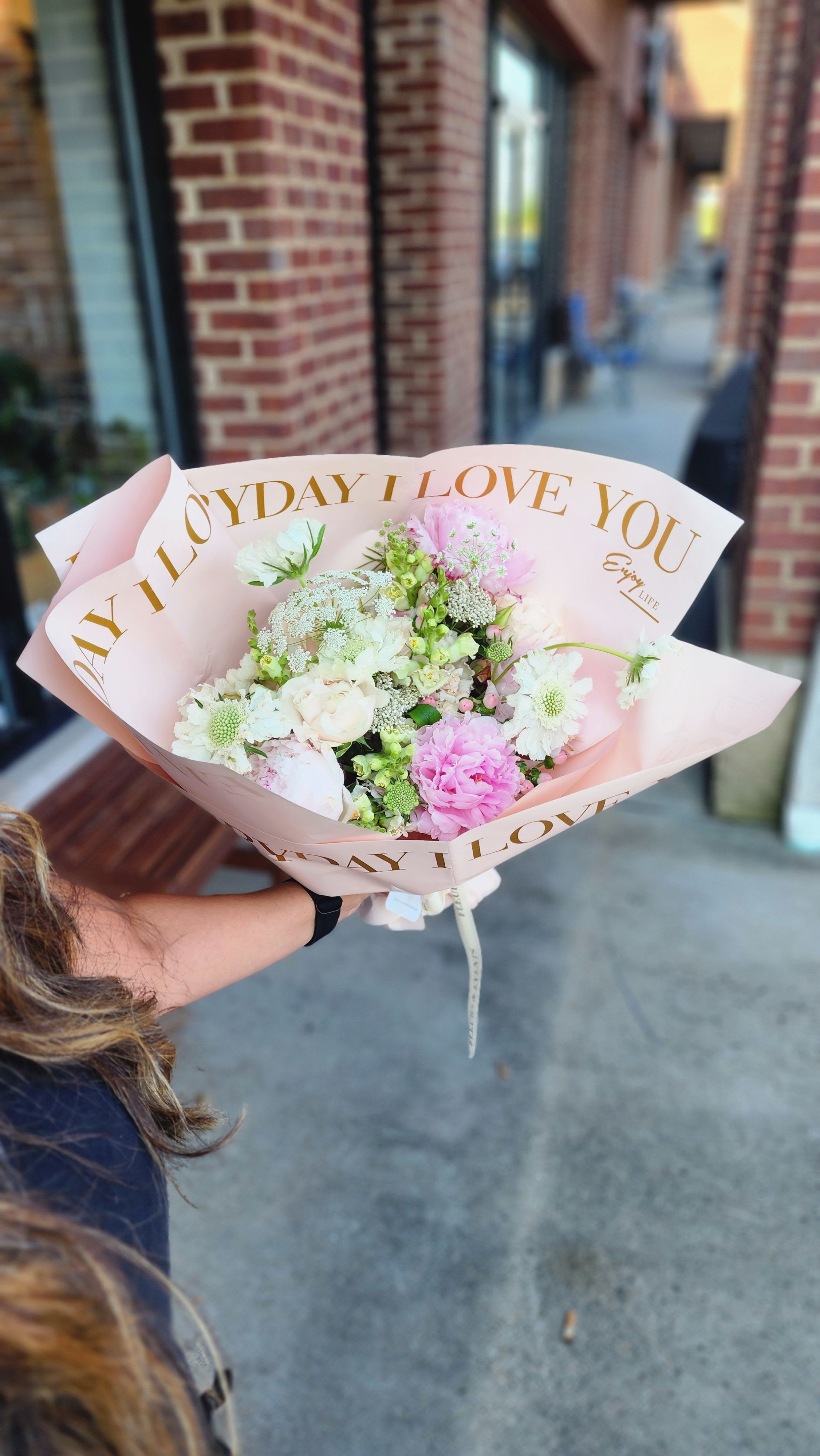 Spring Garden Wrap Bouquet - A hand-tied bouquet inspired by the softness and beauty of a blooming spring garden. Designed with delicate seasonal flowers in shades of blush, soft pink, creamy whites, and fresh greens, this bouquet feels light, airy, and effortlessly romantic.  Featuring premium blooms like peonies, ranunculus, garden roses, and textural accents, each bouquet is thoughtfully arranged with natural movement and wrapped in signature paper for a polished, gift-ready presentation.  Perfect for everyday moments, sweet gestures, or celebrating the season with fresh, garden-inspired beauty.  Please note that the flower varieties pictured may vary due to seasonal availability. However, rest assured that you will receive premium, fresh blooms of equal or greater value, ensuring a beautiful and high-quality arrangement every time.  If any elements of design are of major importance to your order, please include them in the Order Notes section at checkout, or please call or email us directly.
