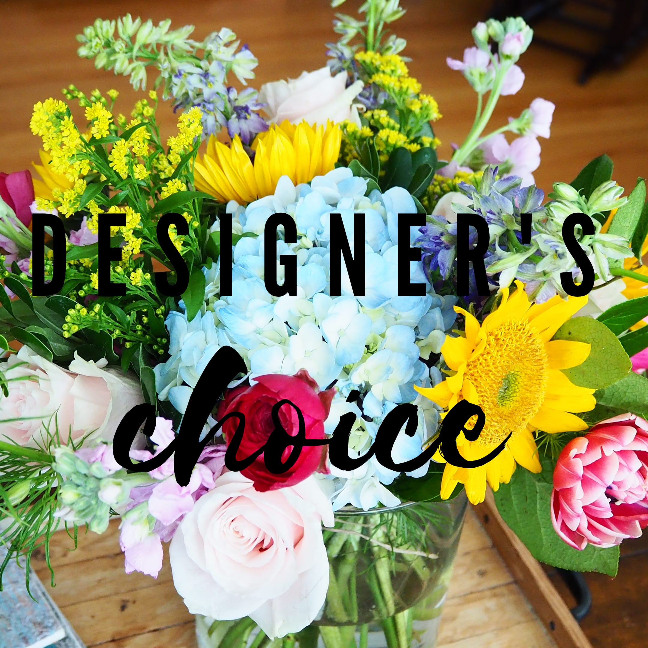 Mixed bouquet with hydrangea, roses, and sunflowers in a glass vase