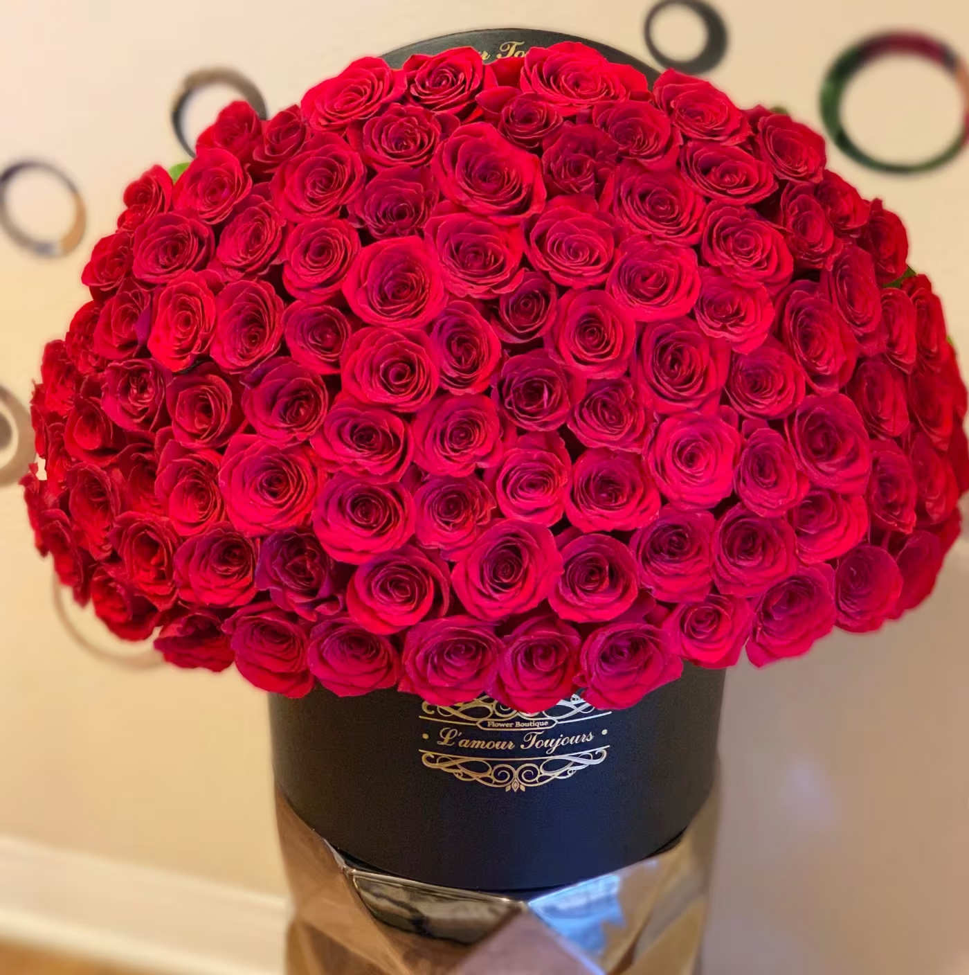 Large dome bouquet of red roses in a black hatbox