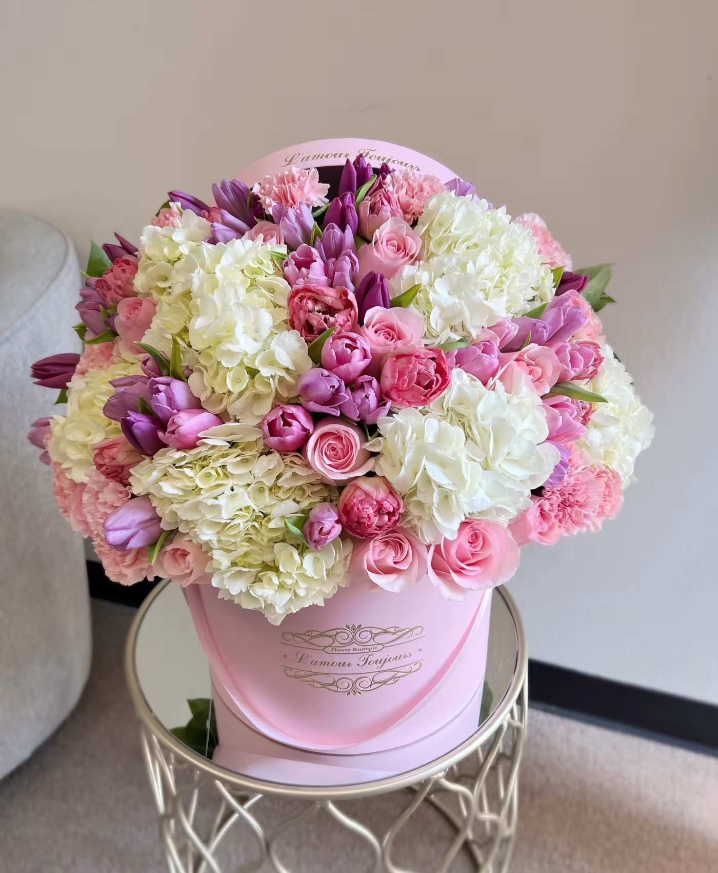 Pink and white bouquet in a round pink box
