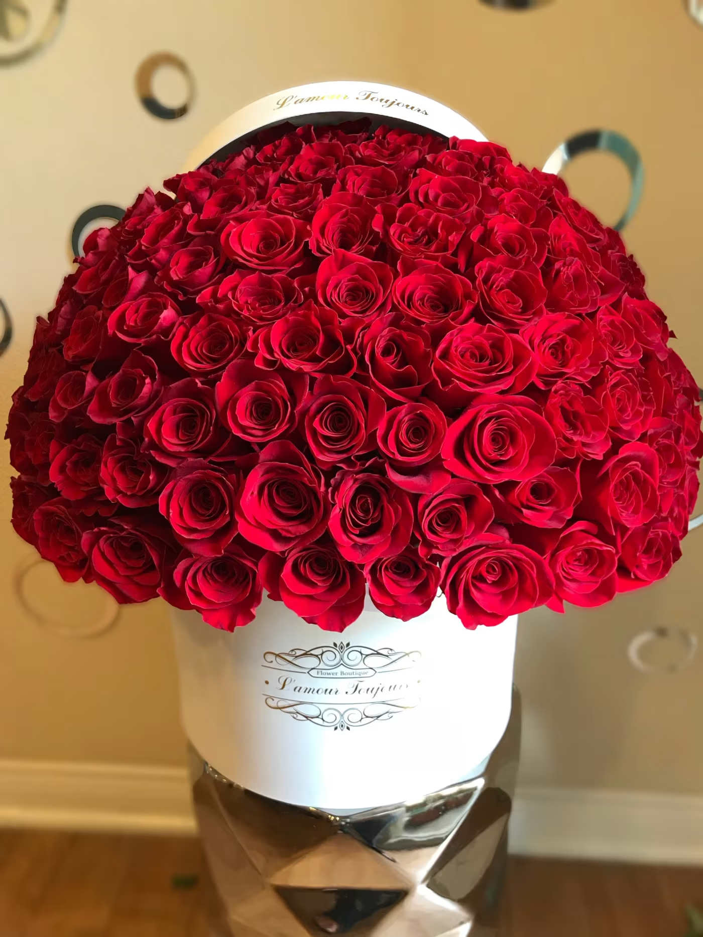 Large bouquet of red roses in a white hatbox