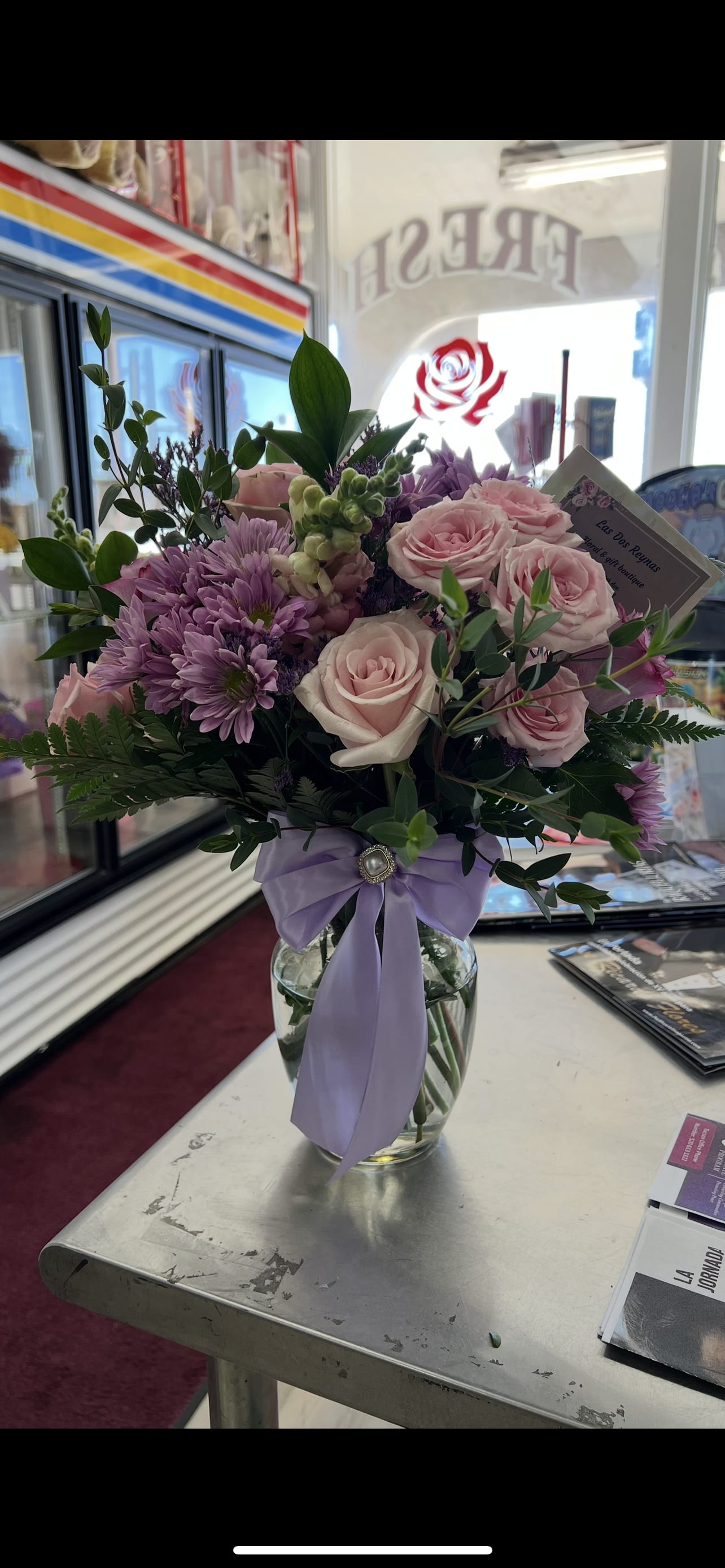 Pastel Perfection - This arrangement has a soft, elegant, romantic feel with blush pink roses, lavender mums, fresh greenery, and a lavender ribbon.