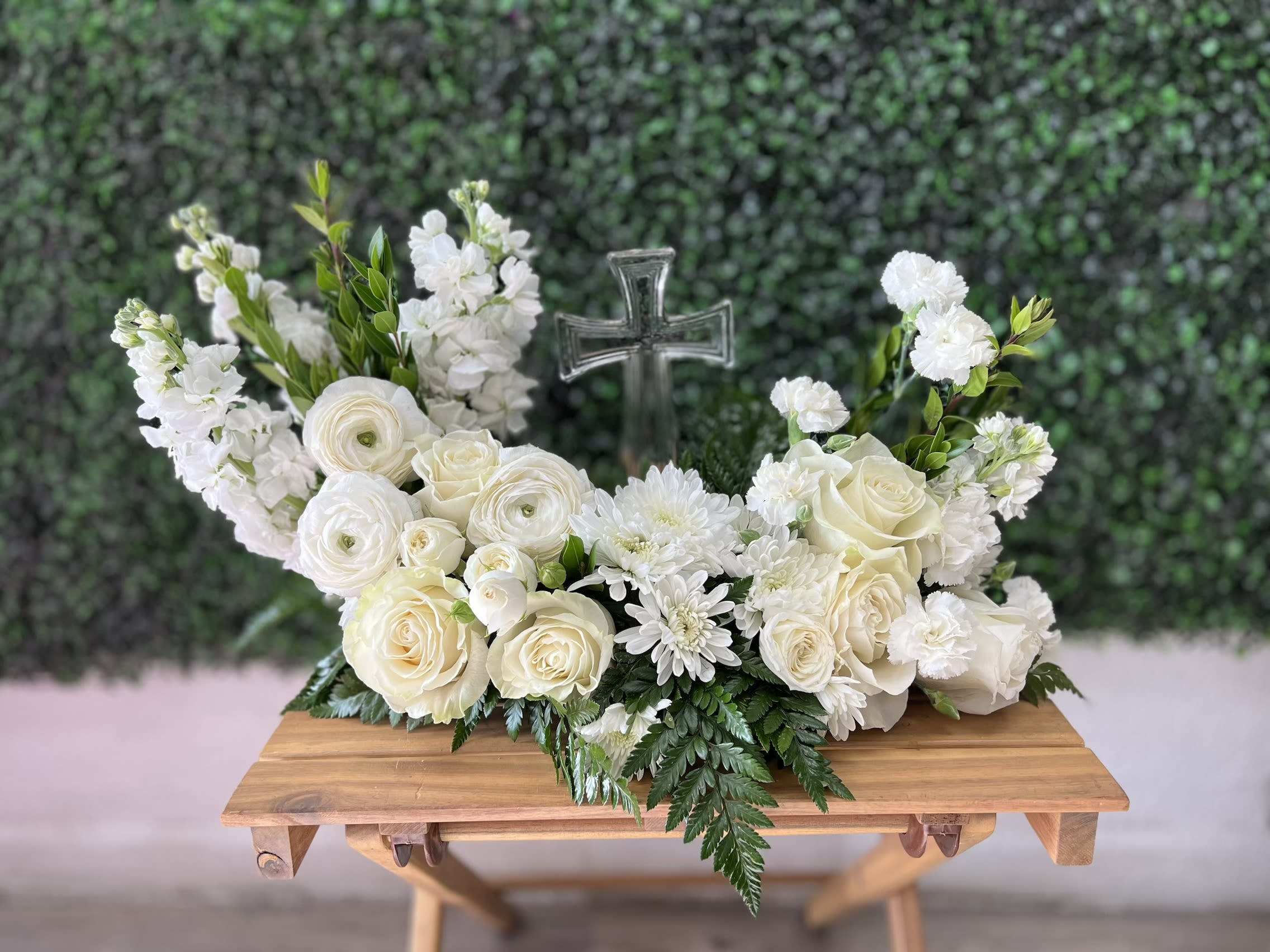Whispers Of Heaven  - An elegant arrangement of white roses and seasonal blooms Surrounding a keepsake cross symbolizing Faith, peace and everlasting love.