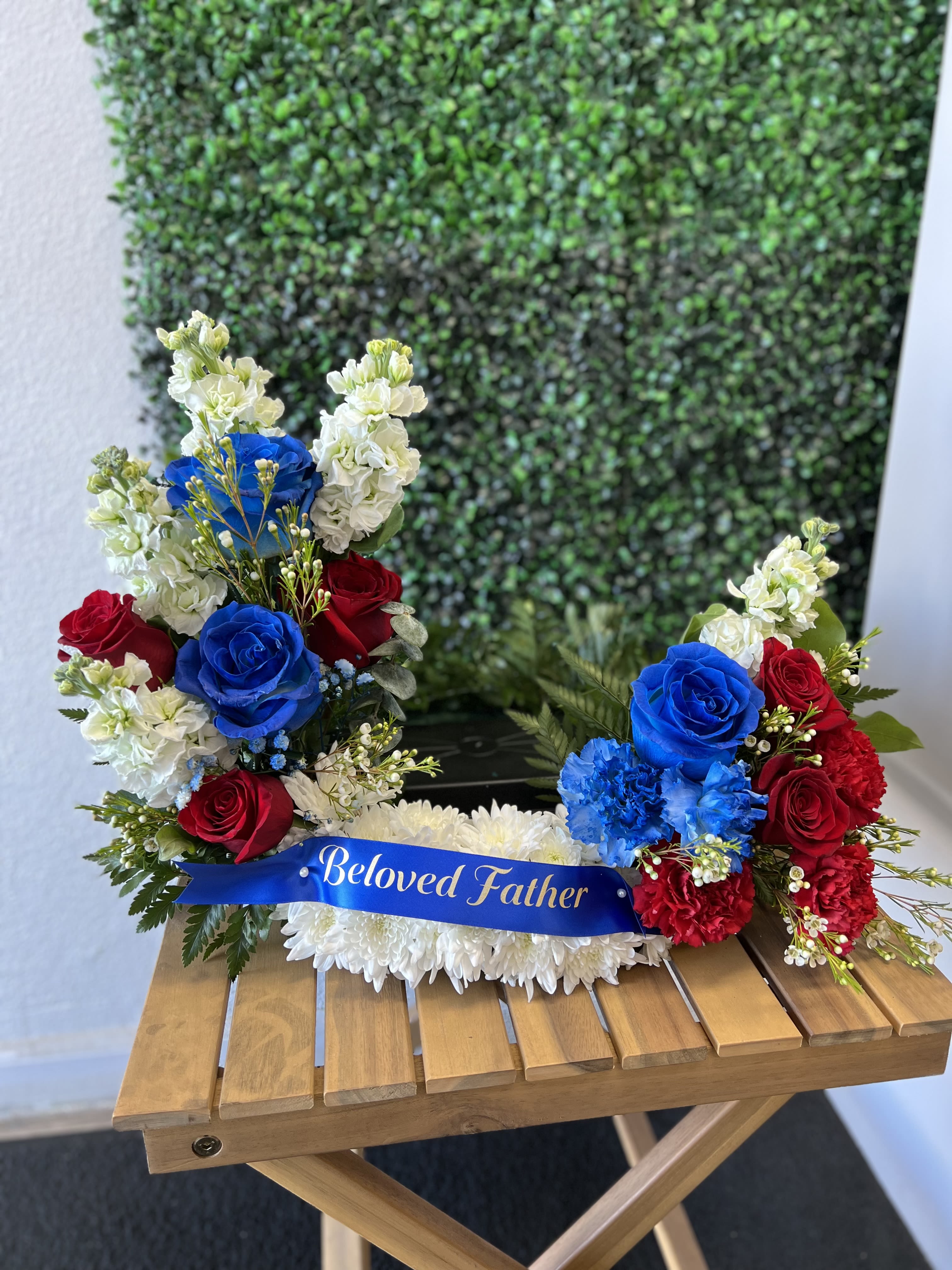  Eternal Honor sympathy urn arrangement  - Celebrate a life of strength, love, and devotion with this striking red, white, and blue sympathy arrangement . Designed with premium roses, carnations, chrysanthemums, and fresh greenery, it offers a meaningful expression of comfort and respect for a cherished father.