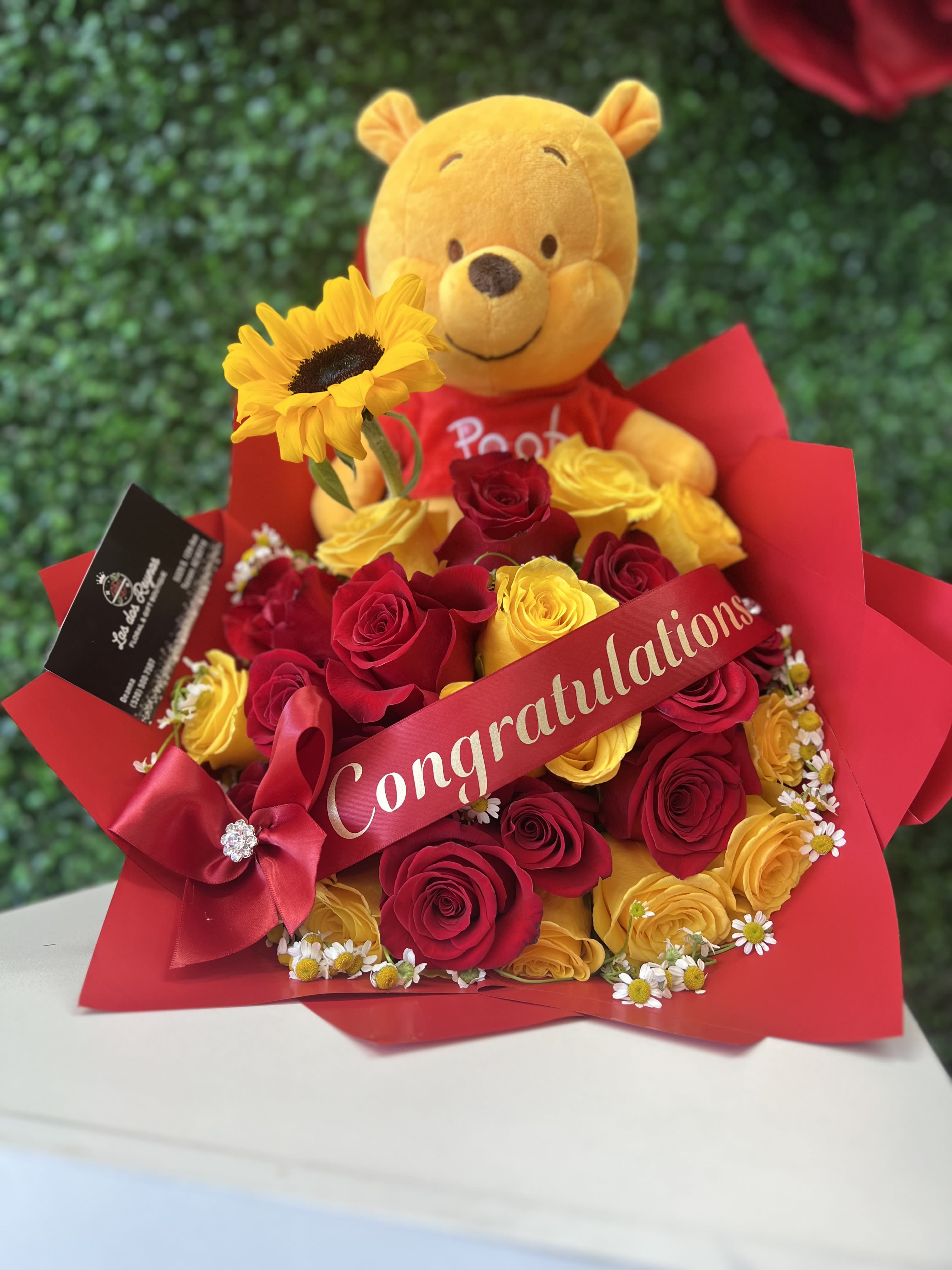 Winne the Pooh  - A joyful arrangement to make someone’s day ! 25 count bouquet with red yellow roses and hints of chamomile filling with a custom ribbon, with Winnie the Pooh plushy 