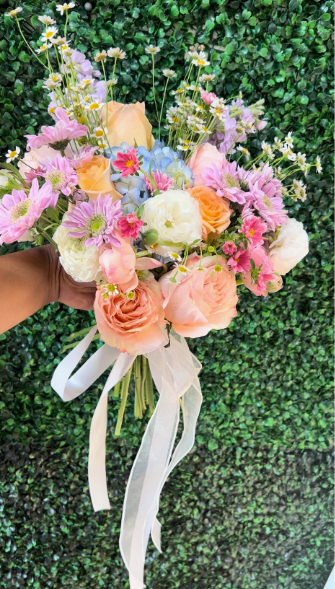 Blushing meadow Bridal Bouquet - A dreamy garden - inspired bridal bouquet soft peach and blush roses delicate daisies, pastel hydrangea and whimsical wildflower accents. (Please note price does change a pond holidays and change in blooms.) 