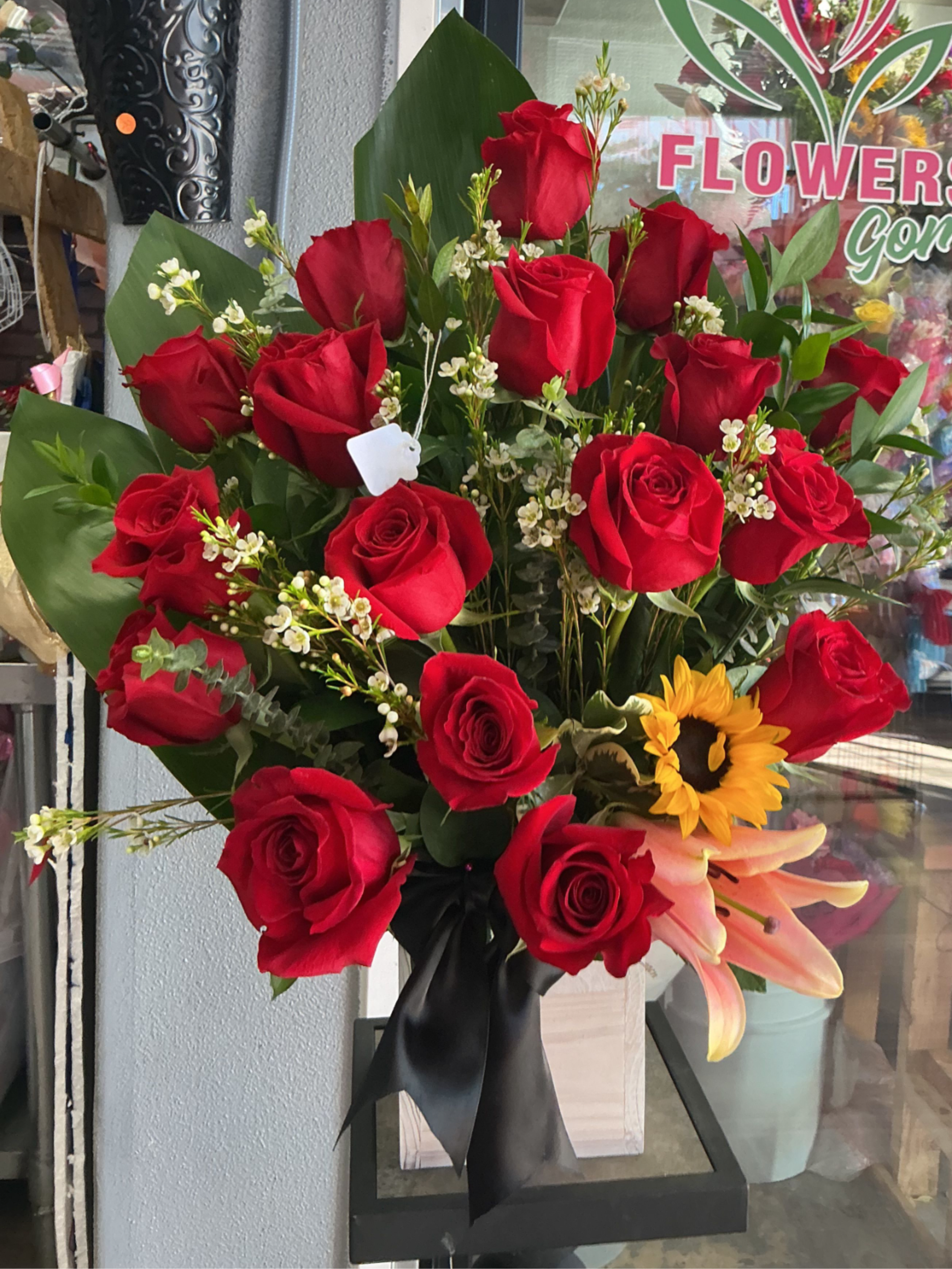 Lovely red  - This arrengment is a perfect gift ,showing your love one some passion with some red roses , light pink lilies , and yellow sunflowers 