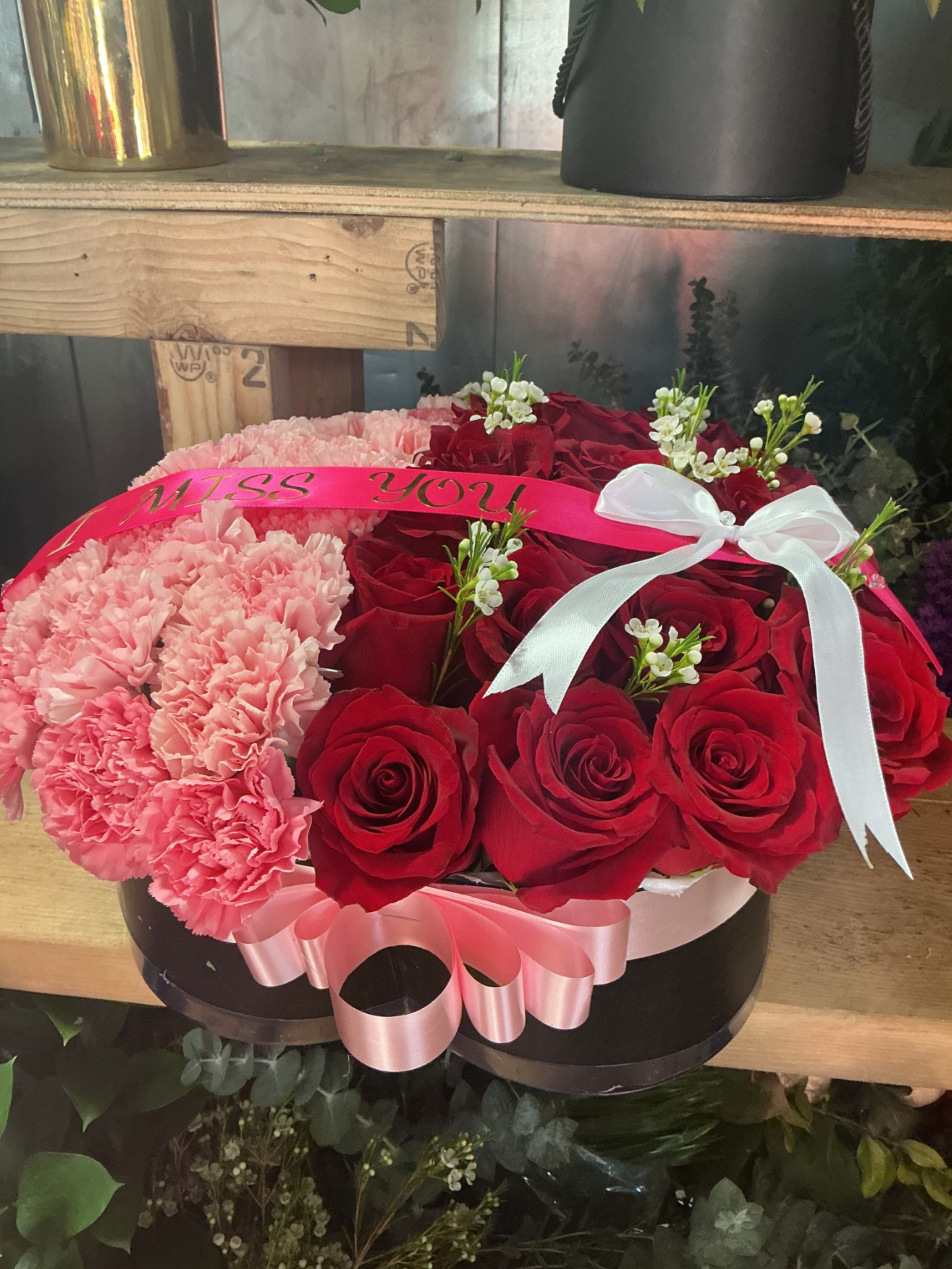 Pure heart  - This beautiful heart is made of red roses and baby pink carnations with bows but we can costumize as you like 