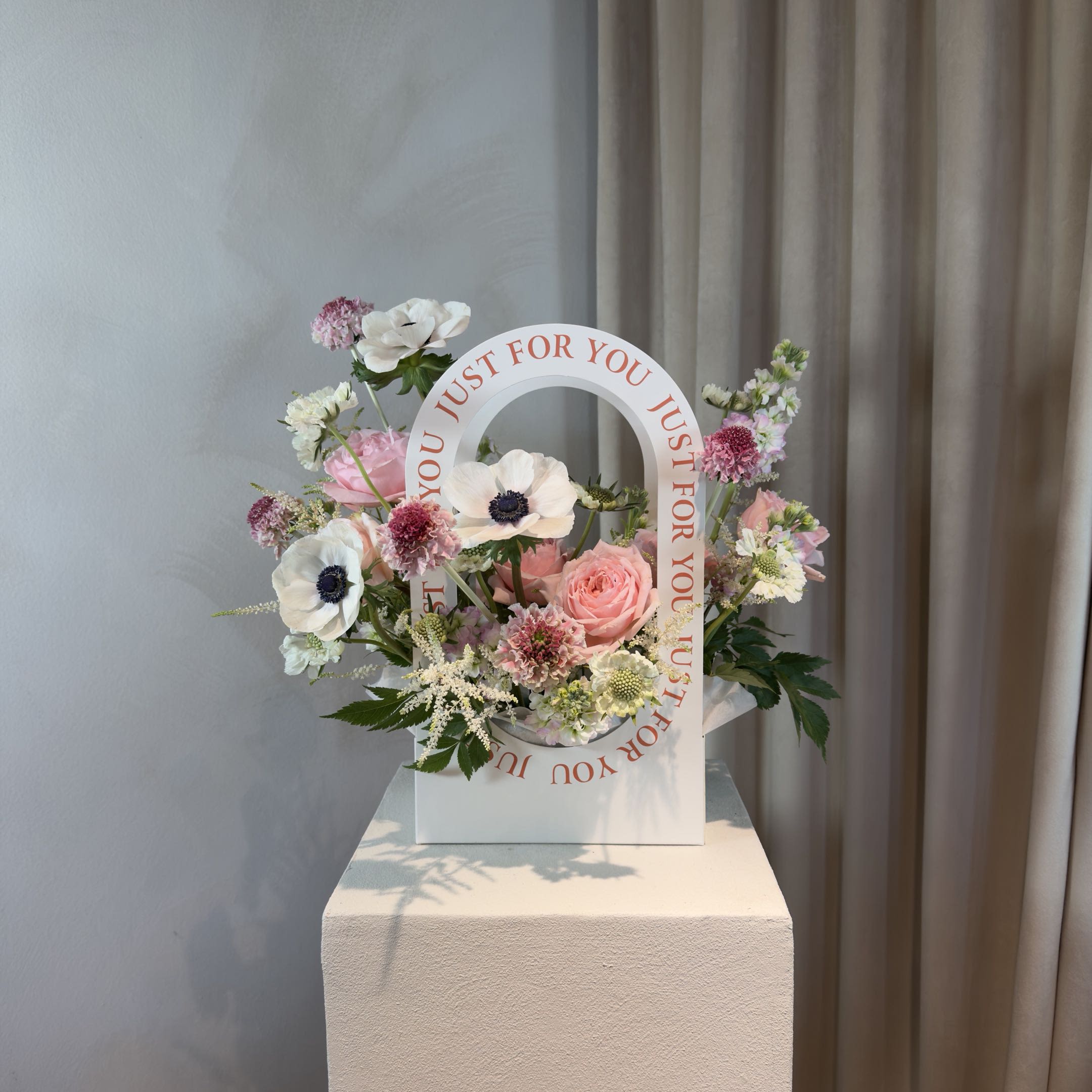White Sarang Box - Sarang (사랑), meaning love in Korean, is our modern take on flowers in a box. Designed with a hand-selected mix of seasonal blooms, interesting textures, and natural movement, each arrangement is created from scratch with its own shape, color combinations, and personality. From soft and delicate to bold and unexpected, every Sarang Box follows our designer's creative direction. No fixed recipes. No repeated designs. Presented in our signature floral box, ready to enjoy.  WHAT'S INCLUDED Original floral design with fresh seasonal flowers Signature box presentation Handwritten message card Flower care instructions  ORDERING &amp; DELIVERY We recommend ordering 2–3 days in advance for the best flower selection. Next-day delivery is available for most orders. For same-day or weekend availability, call or text 704.975.2774.  PLEASE NOTE Product images are for inspiration only. Flower varieties, colors, textures, and overall composition will vary based on seasonal availability and our designer's creative direction. We do not repeat previous designs or recreate another florist's work.  FINAL SALE POLICY All orders are final sale. Due to the custom and perishable nature of our floral designs, cancellations, refunds, or exchanges are not accepted once an order is placed.