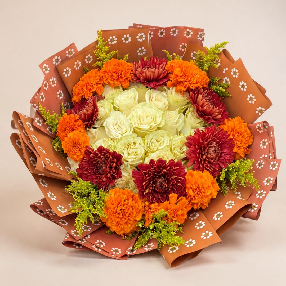 Bouquet of white roses with orange and burgundy flowers in patterned wrap
