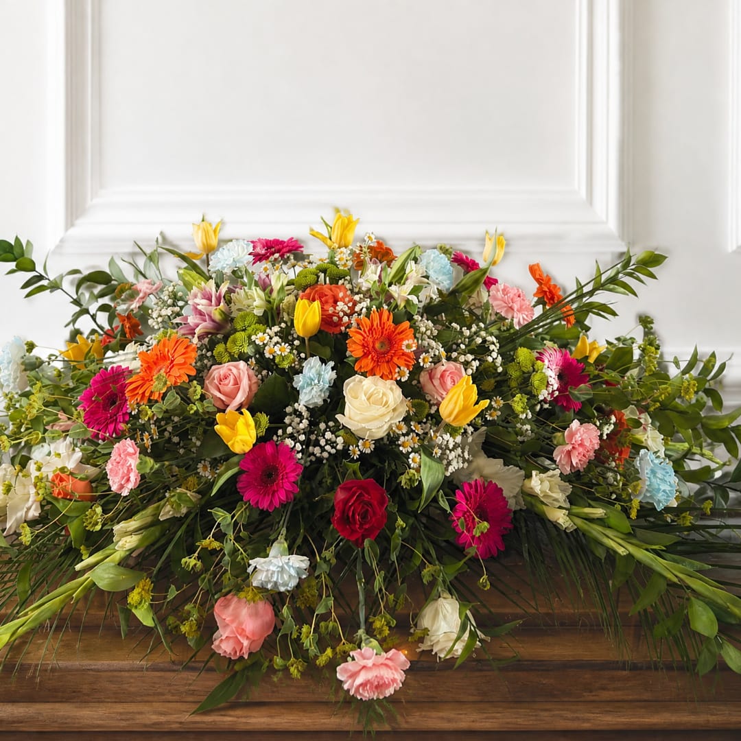 Large mixed floral arrangement with roses, tulips, and gerbera daisies