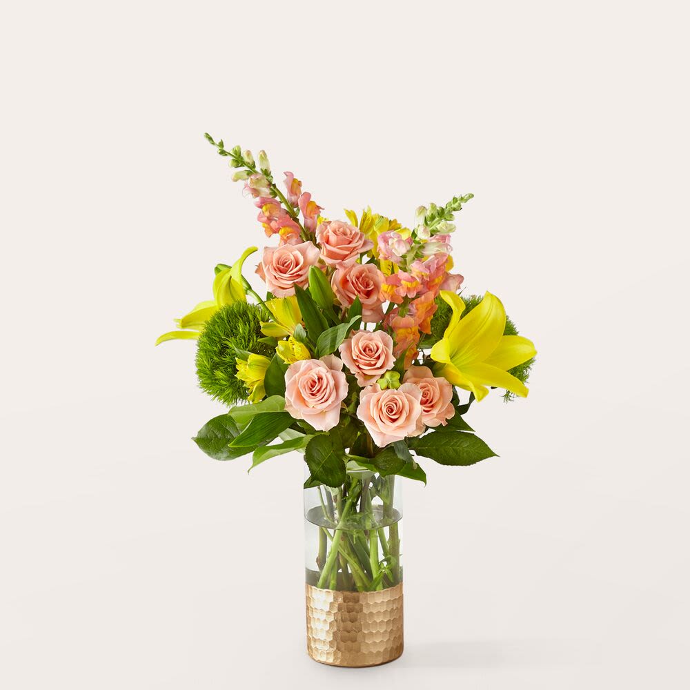 Getaway Bouquet - Take a trip to somewhere warm with this sunny bouquet, bursting with peach spray roses, orange snapdragon, alstroemeria and yellow lilies.