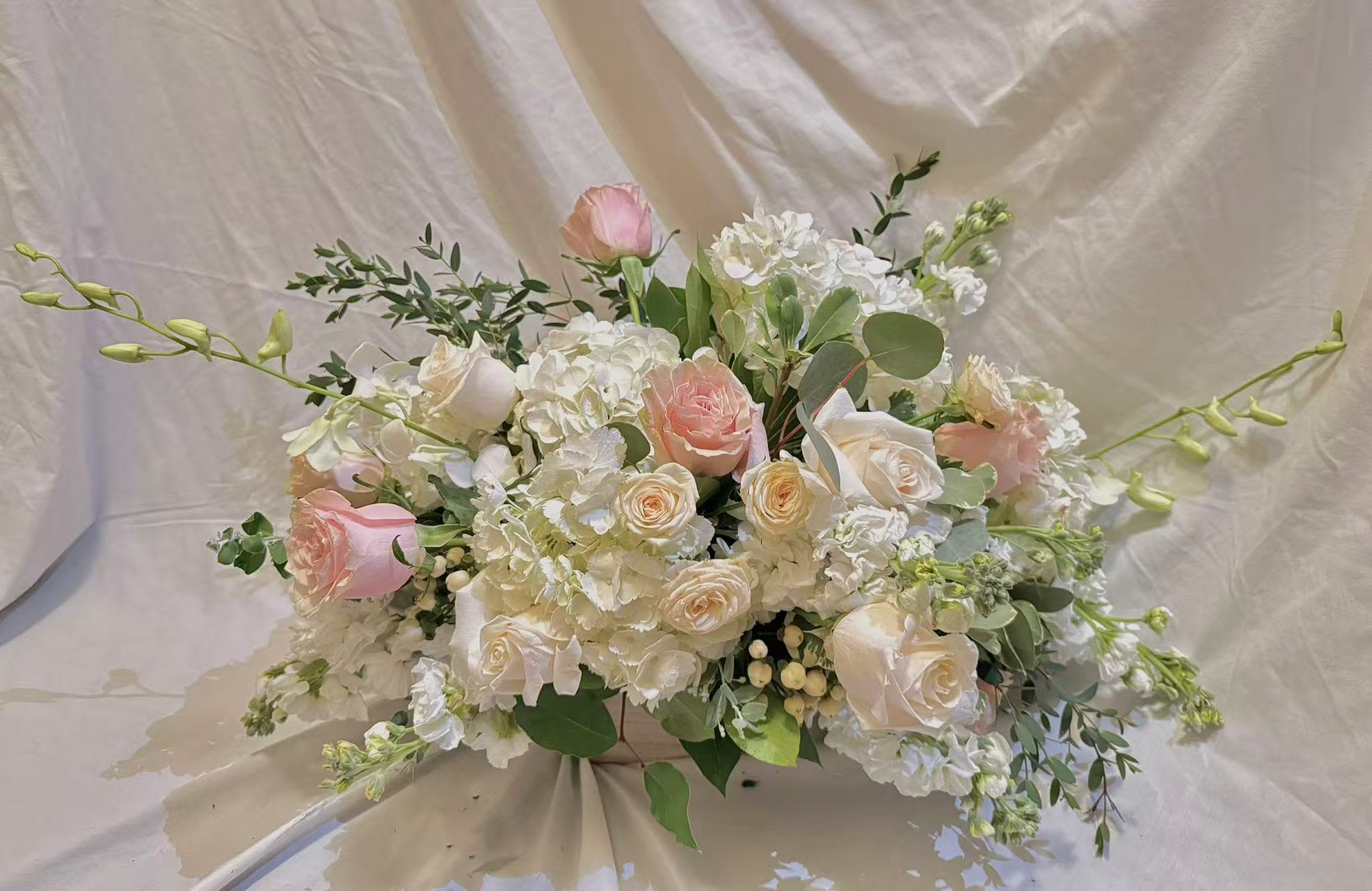 Blush and white floral arrangement with roses and hydrangeas