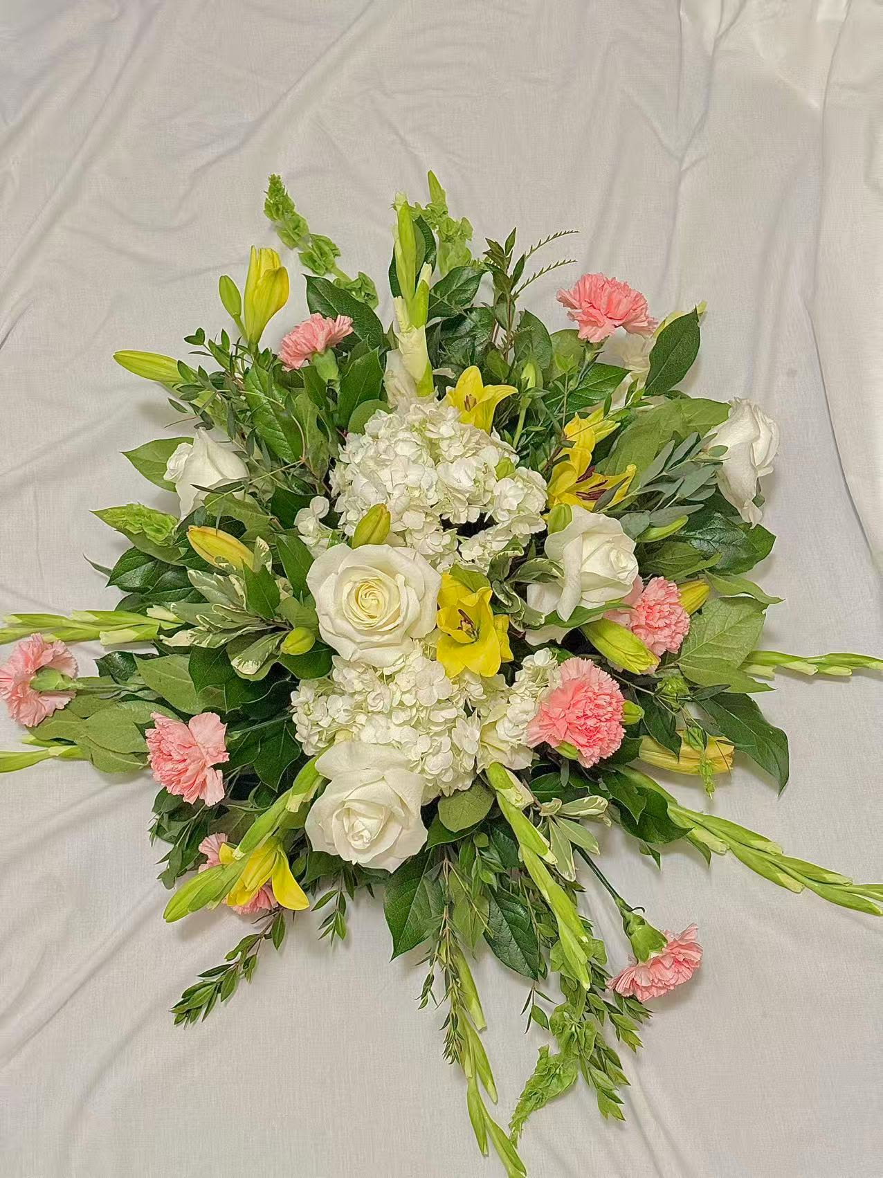 Round bouquet of white roses, lilies, and pink carnations