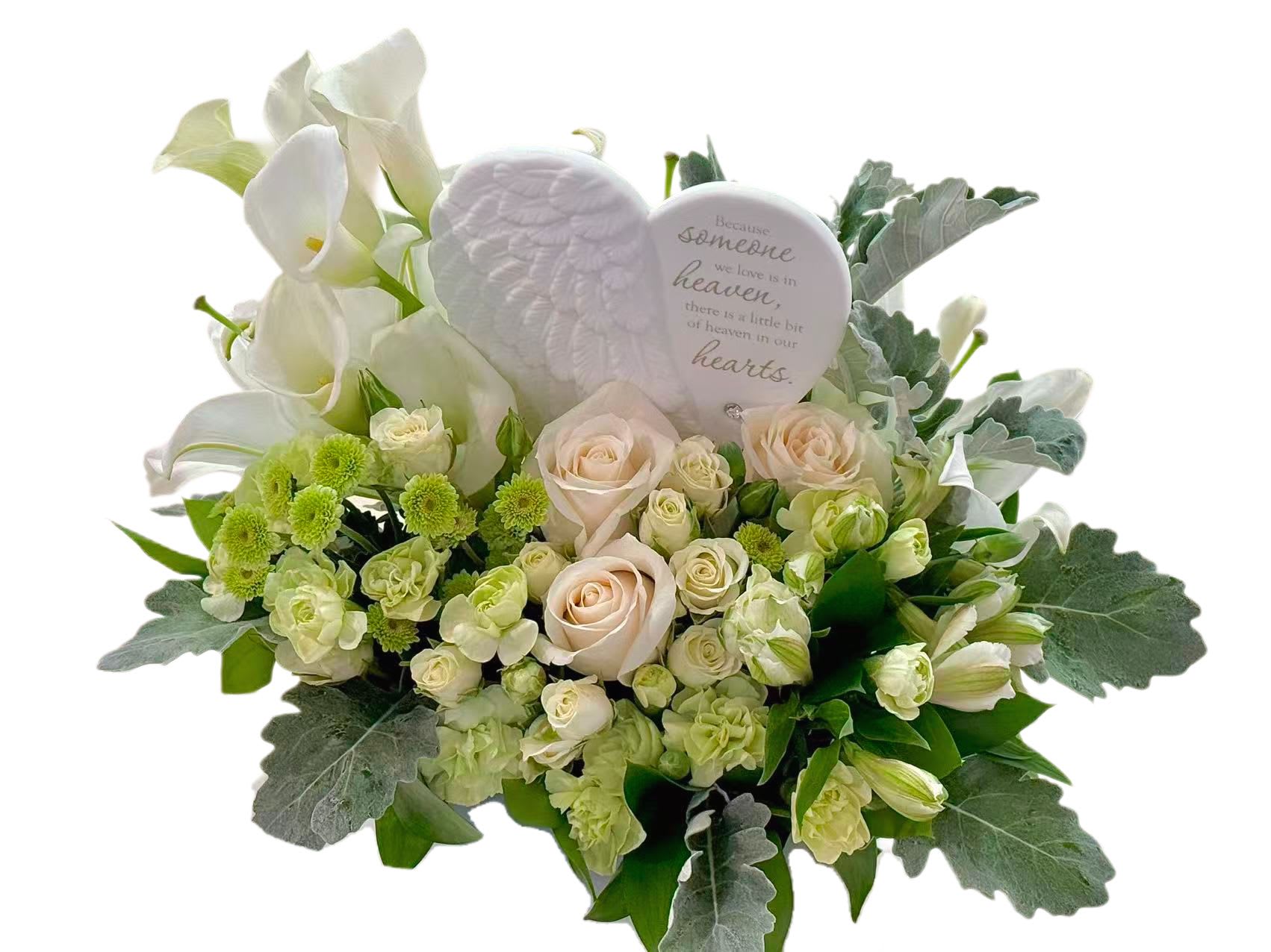 White calla lilies and pale roses with a memorial heart plaque