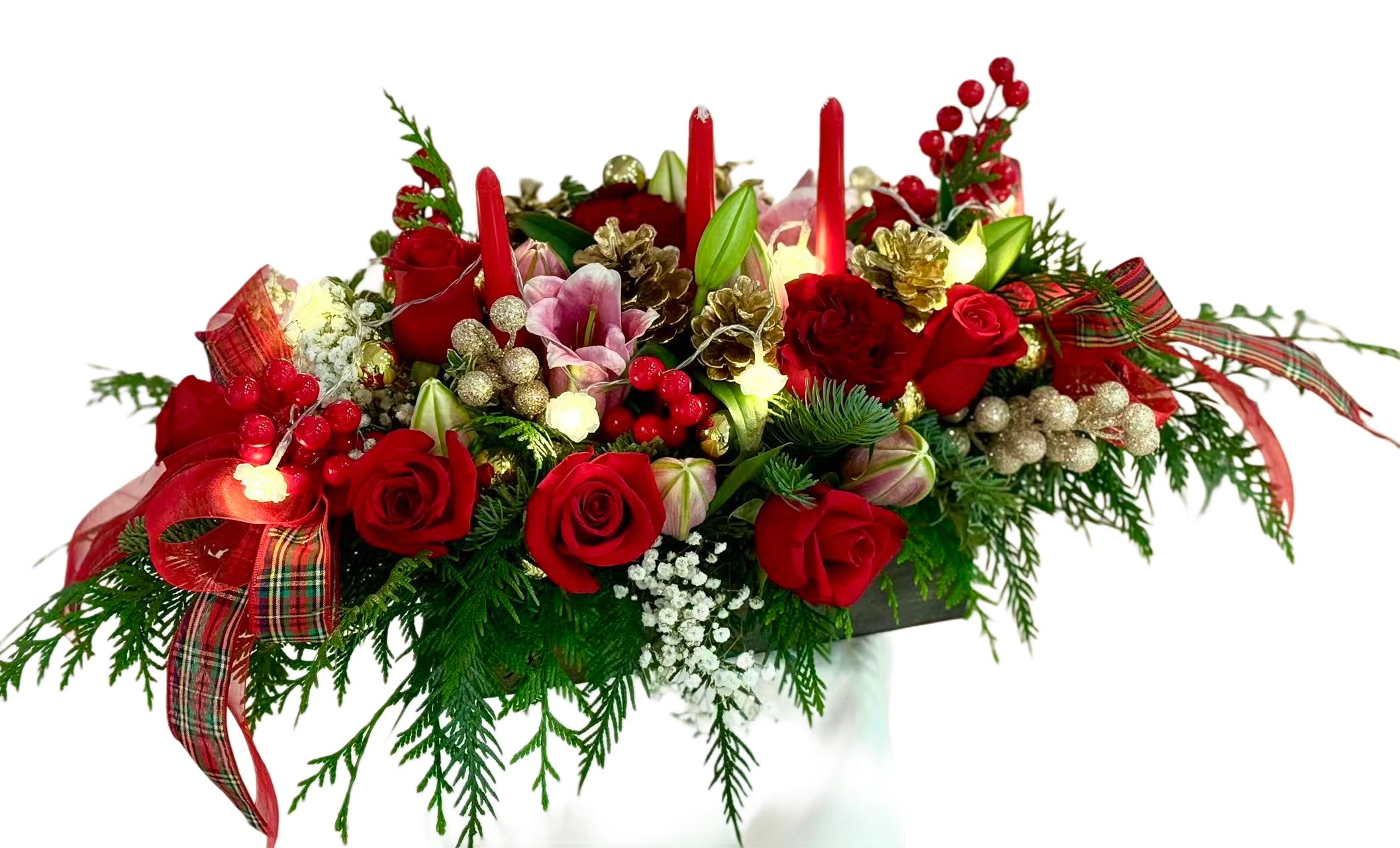 Red rose centerpiece with candles, pinecones, and plaid ribbon