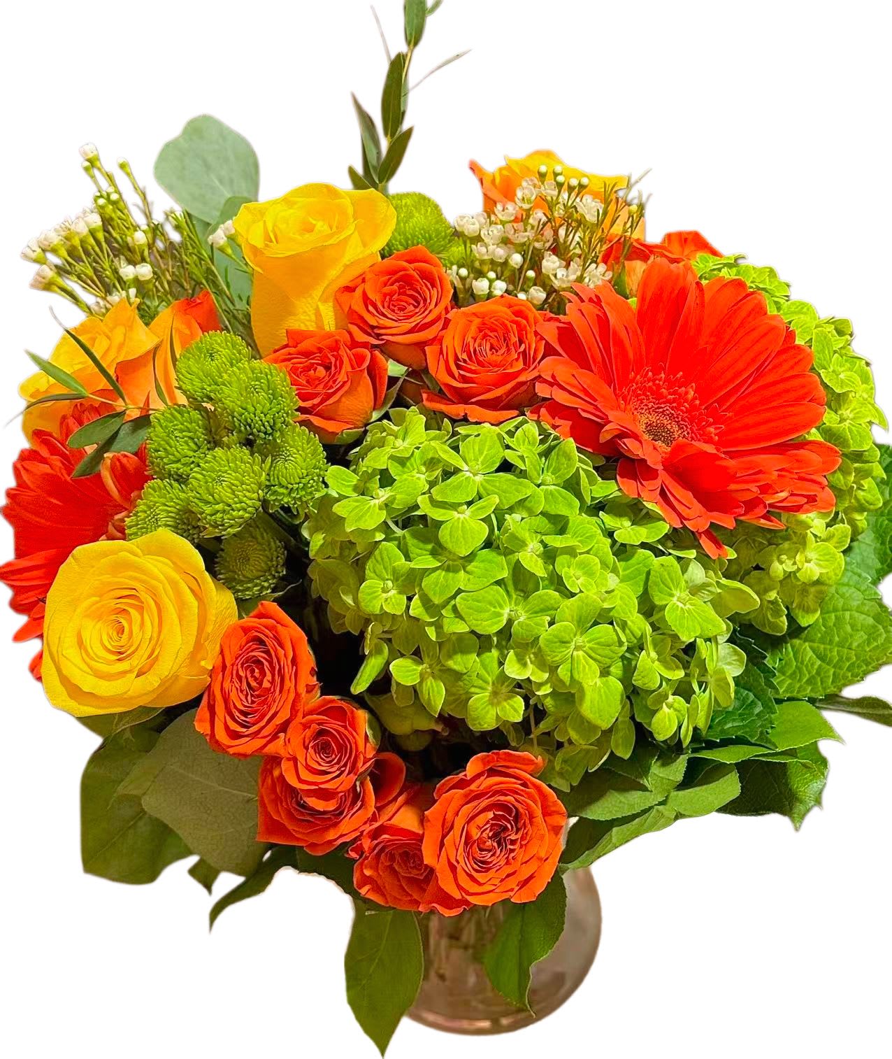 Bouquet of orange and yellow roses with a bright green hydrangea in a vase.