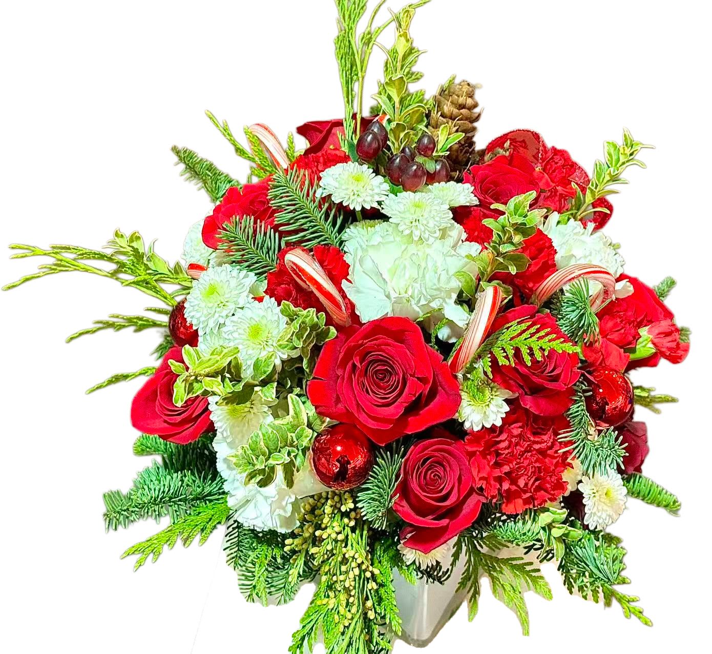 Red roses and white flowers in a vase with pine and ornaments