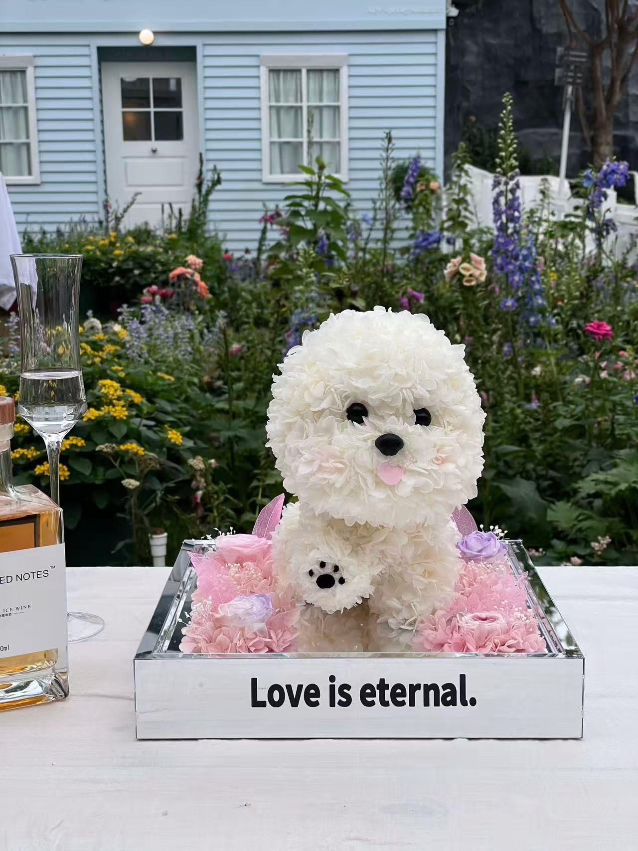 White floral dog sculpture in a mirrored box with pink flowers