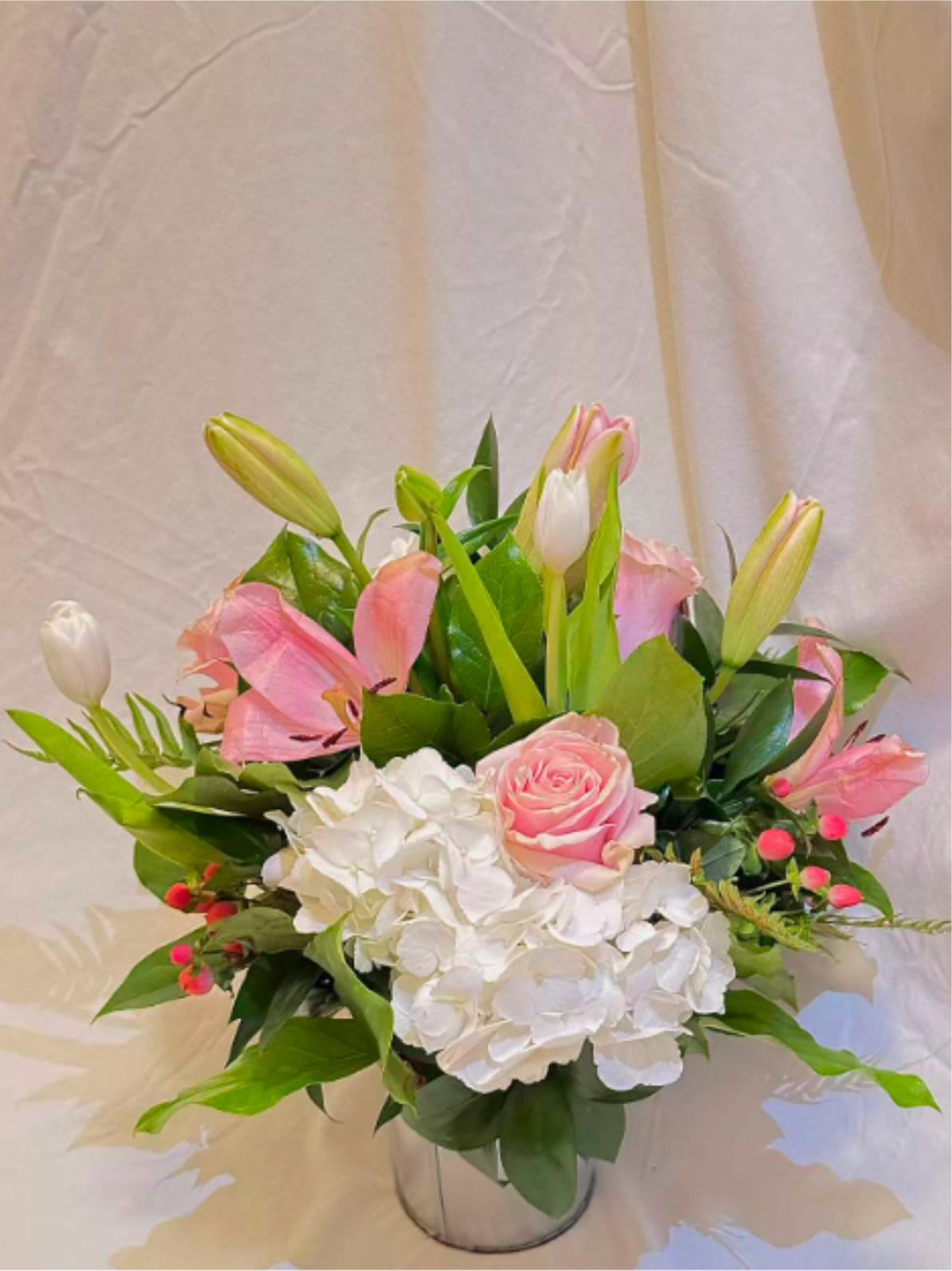 Blush Garden Grace | Soft Pink Floral Arrangement - A soft and romantic garden-style floral arrangement featuring white hydrangeas, blush pink roses, delicate pink blooms, and seasonal greenery. Designed with a natural, airy silhouette, this arrangement brings a sense of calm, elegance, and warmth to any space.  Perfect for birthdays, thank you gifts, thinking-of-you moments, or just because. Each arrangement is handcrafted using premium seasonal flowers and may vary slightly while maintaining the same color palette, style, and overall look.